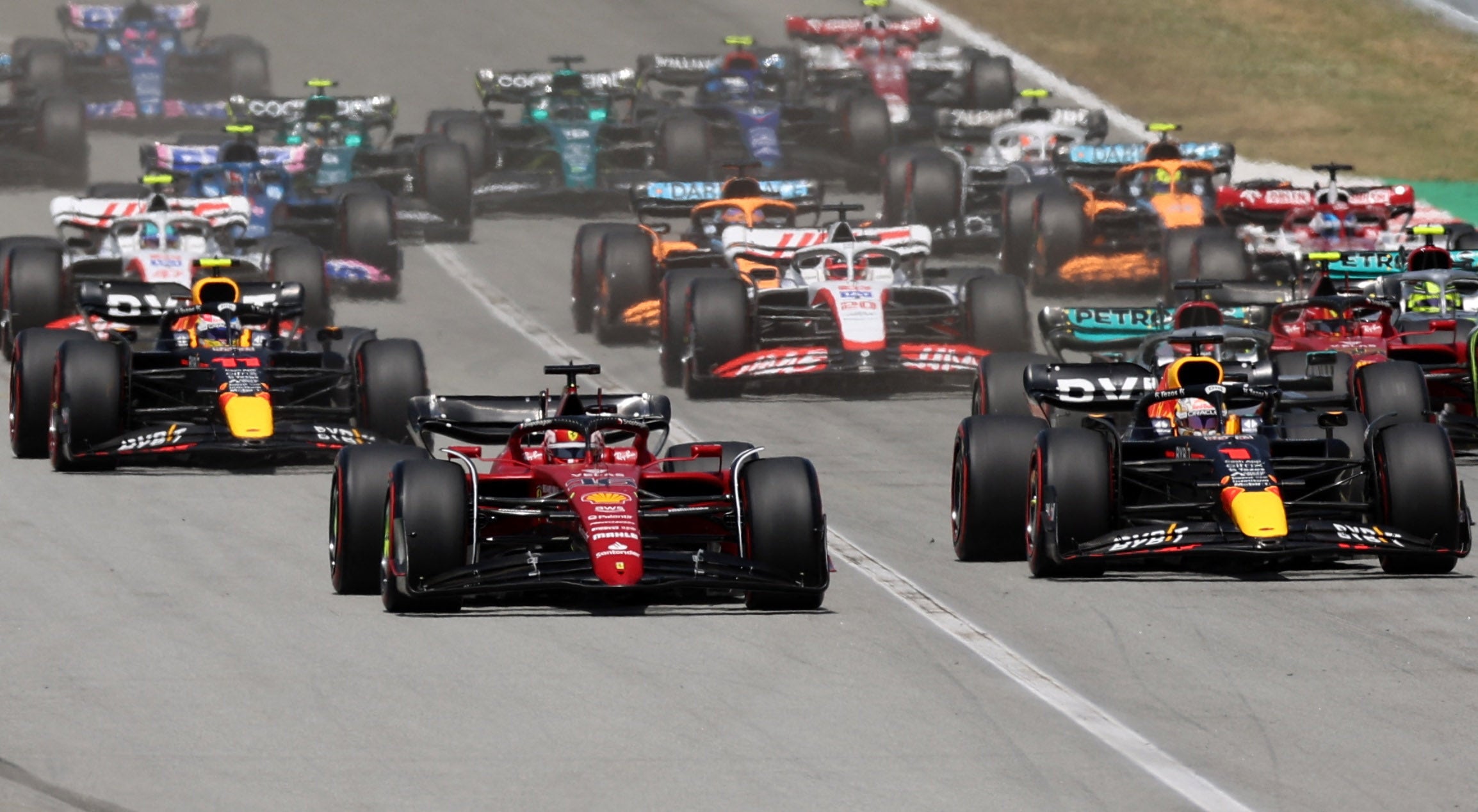 Ferrari's Charles Leclerc leads Red Bull's Verstappen at the start of the race