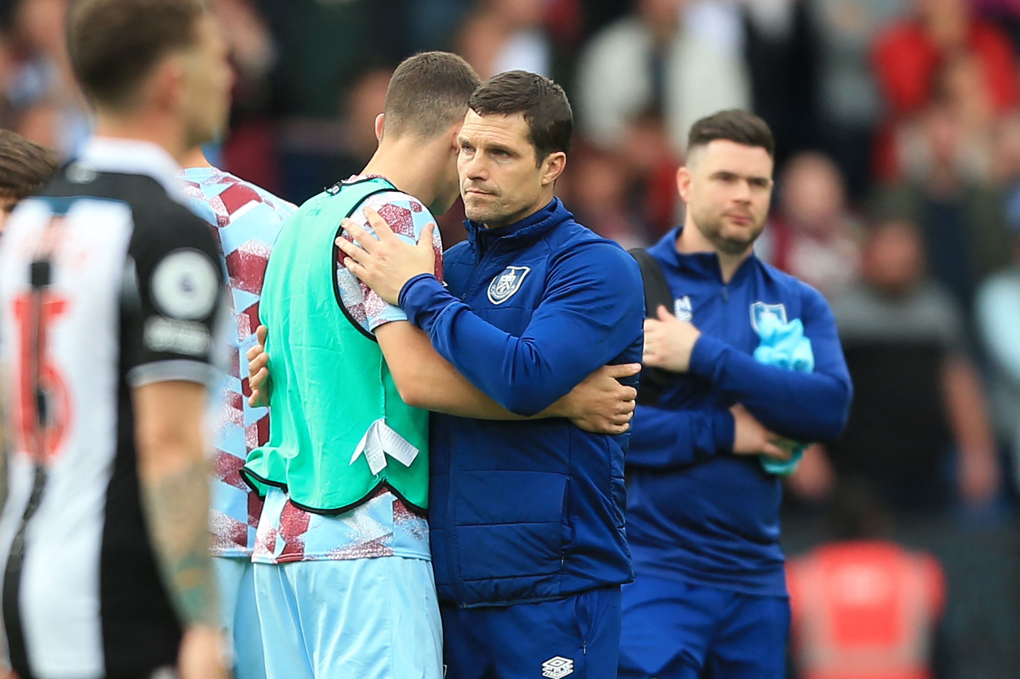 Burnley manager Mike Jackson consoles his players