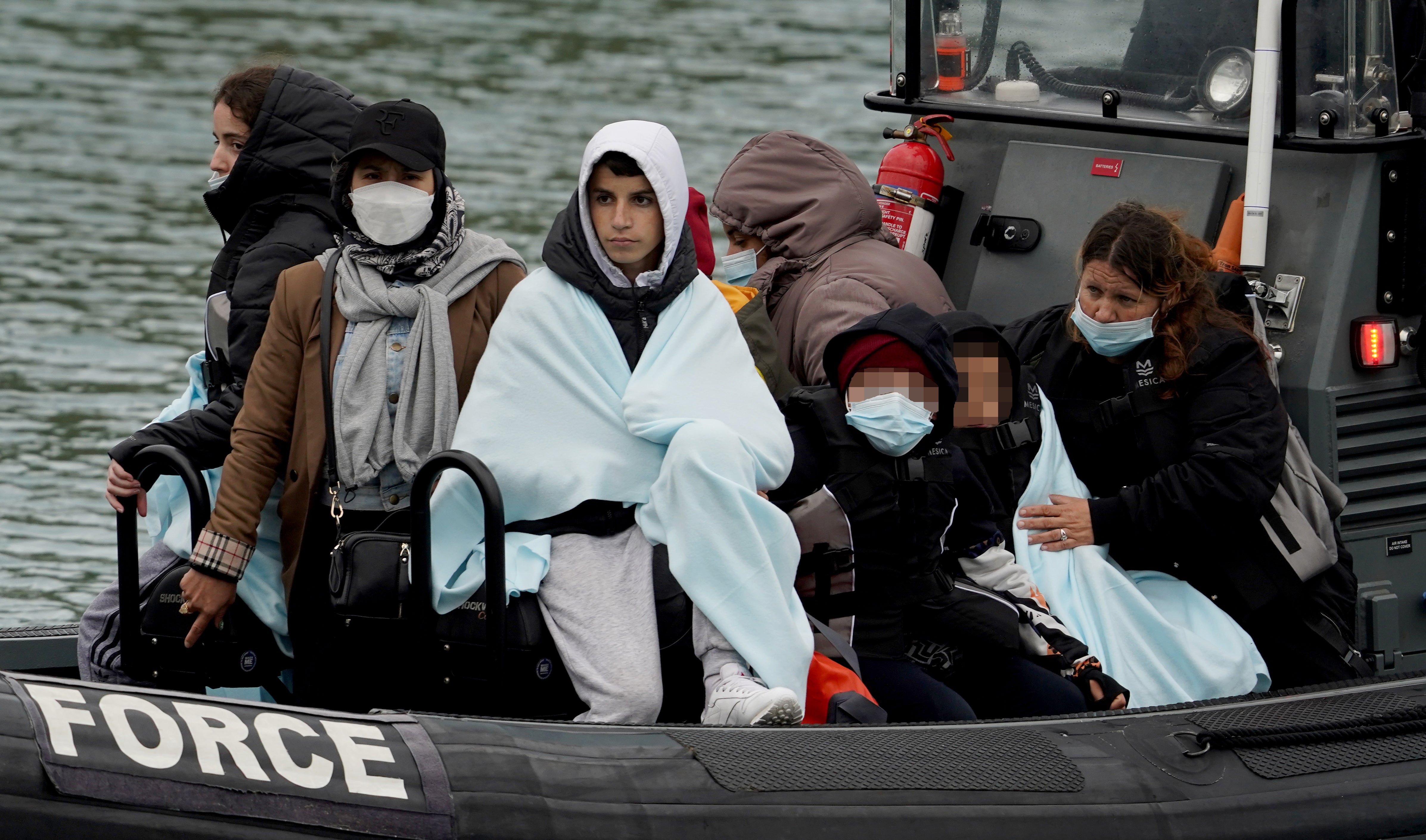 Children amongst group of people thought to be migrants are brought in to Dover, Kent, onboard a Border Force vessel, following a small boat incident in the Channel (PA)