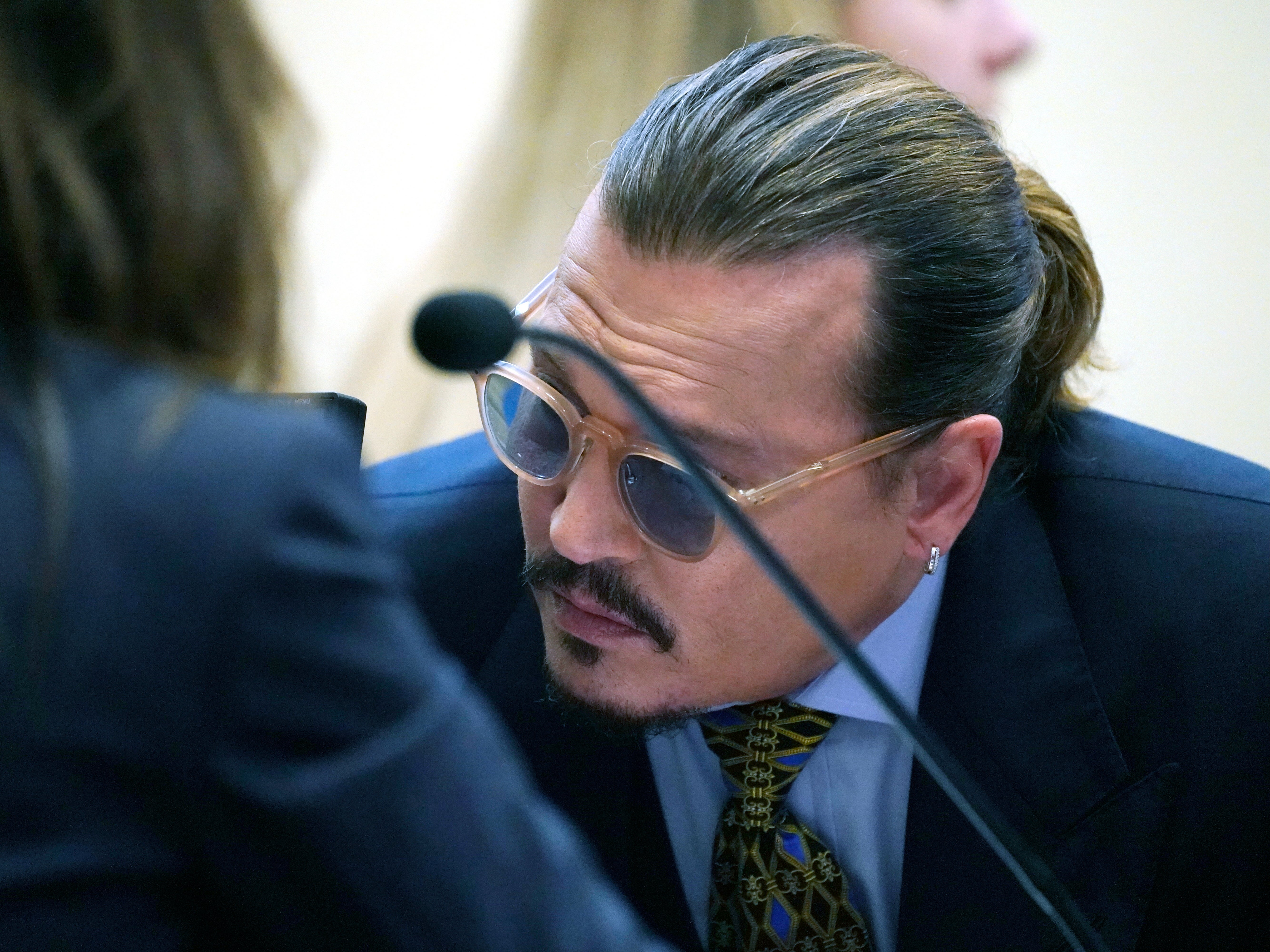 Actor Johnny Depp talks to his attorney, in the courtroom at the Fairfax County Circuit Courthouse in Fairfax, Virginia, USA, 23 May 2022