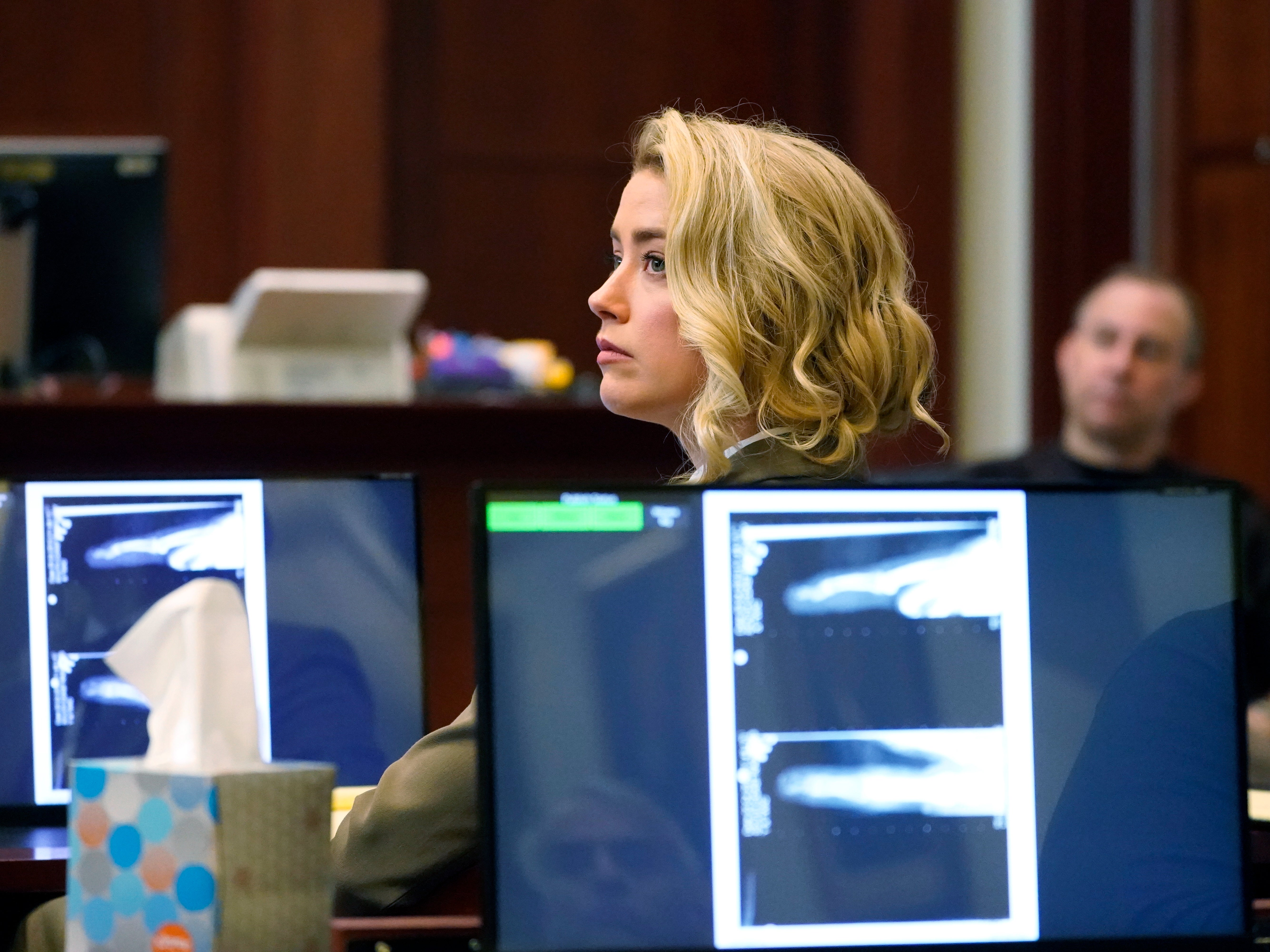 Actor Amber Heard listens in the courtroom at the Fairfax County Circuit Courthouse in Fairfax, Virginia, USA, 23 May 2022