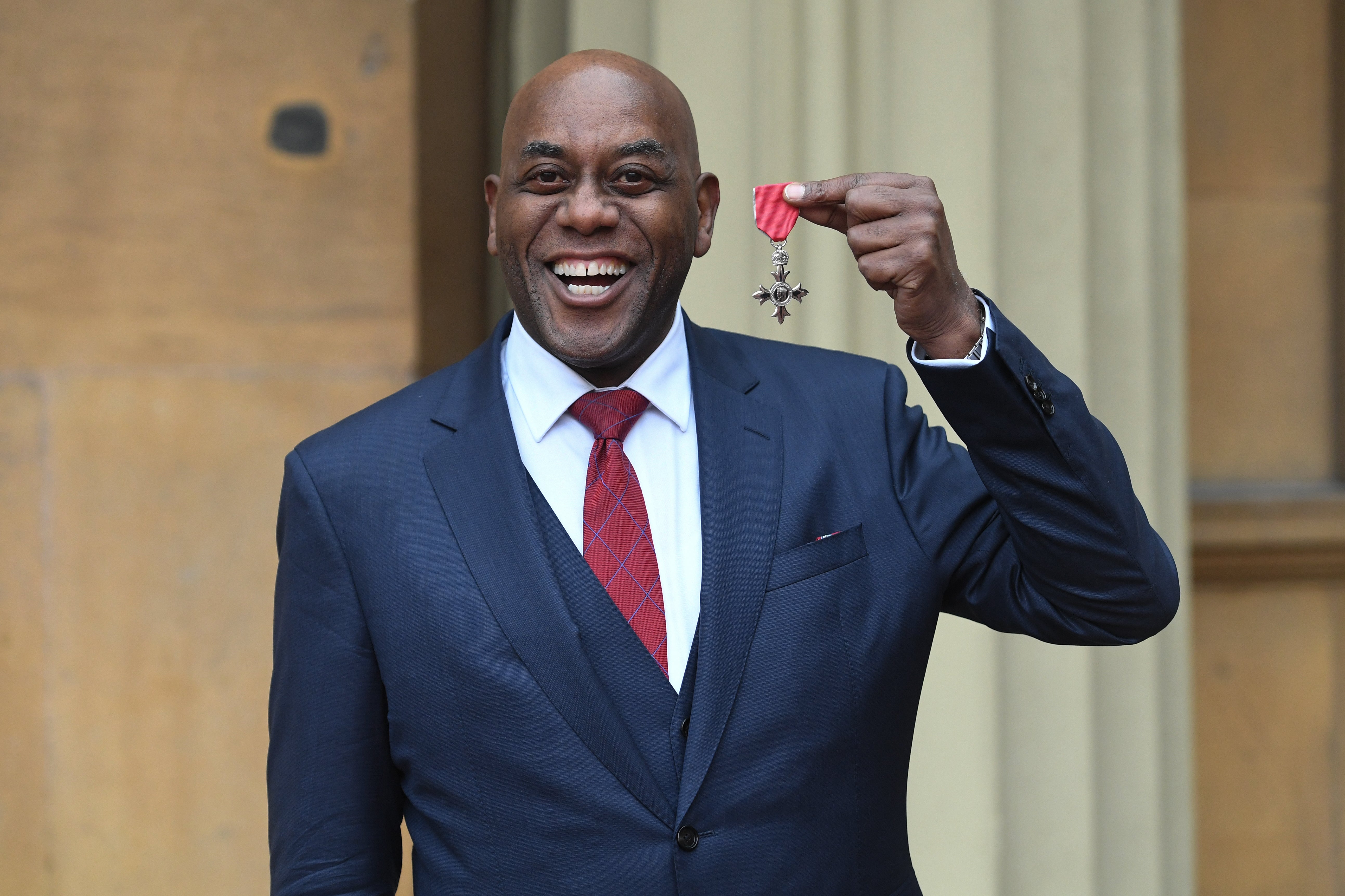 Ainsley Harriott with his MBE at Buckingham Palace in 2020