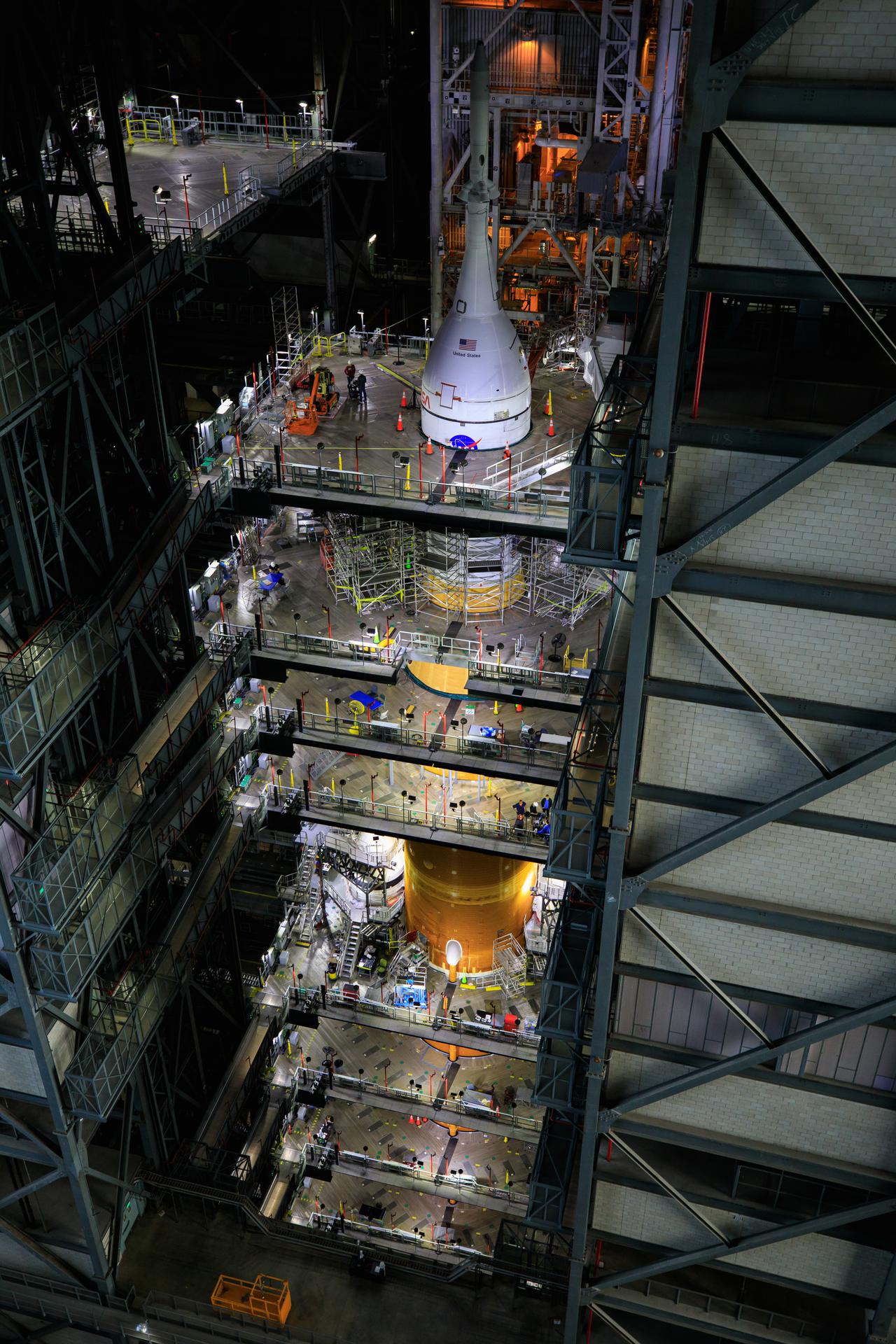 Ground teams work on Nasa’s Space Launch System Moon rocket and Orion spacecraft inside the Vehicle Assembly Building at Kennedy Space Center in Florida