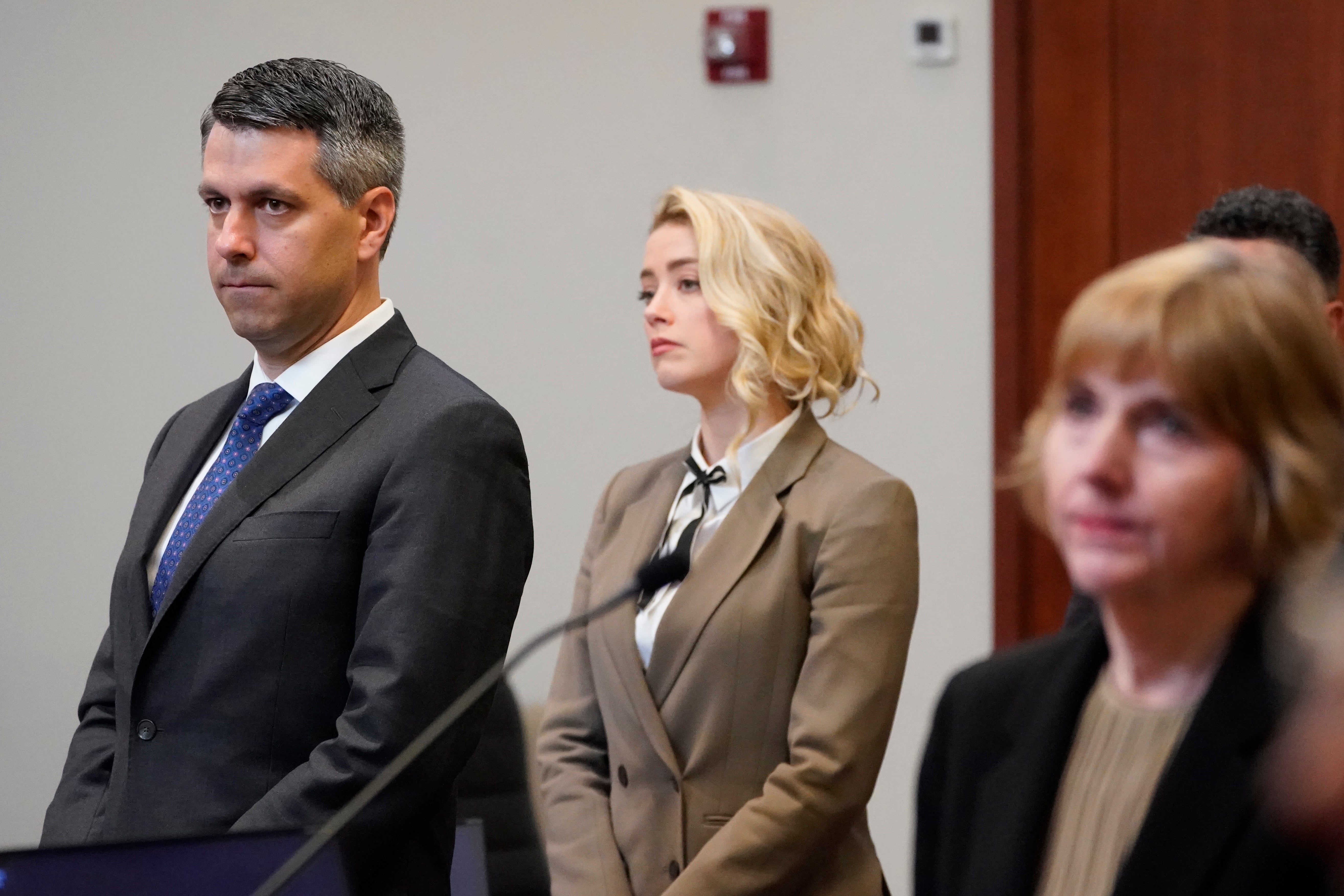 Actor Amber Heard watches as the jury arrives into the courtroom after a break at the Fairfax County Circuit Courthouse in Fairfax, Va., Monday, May 23, 2022