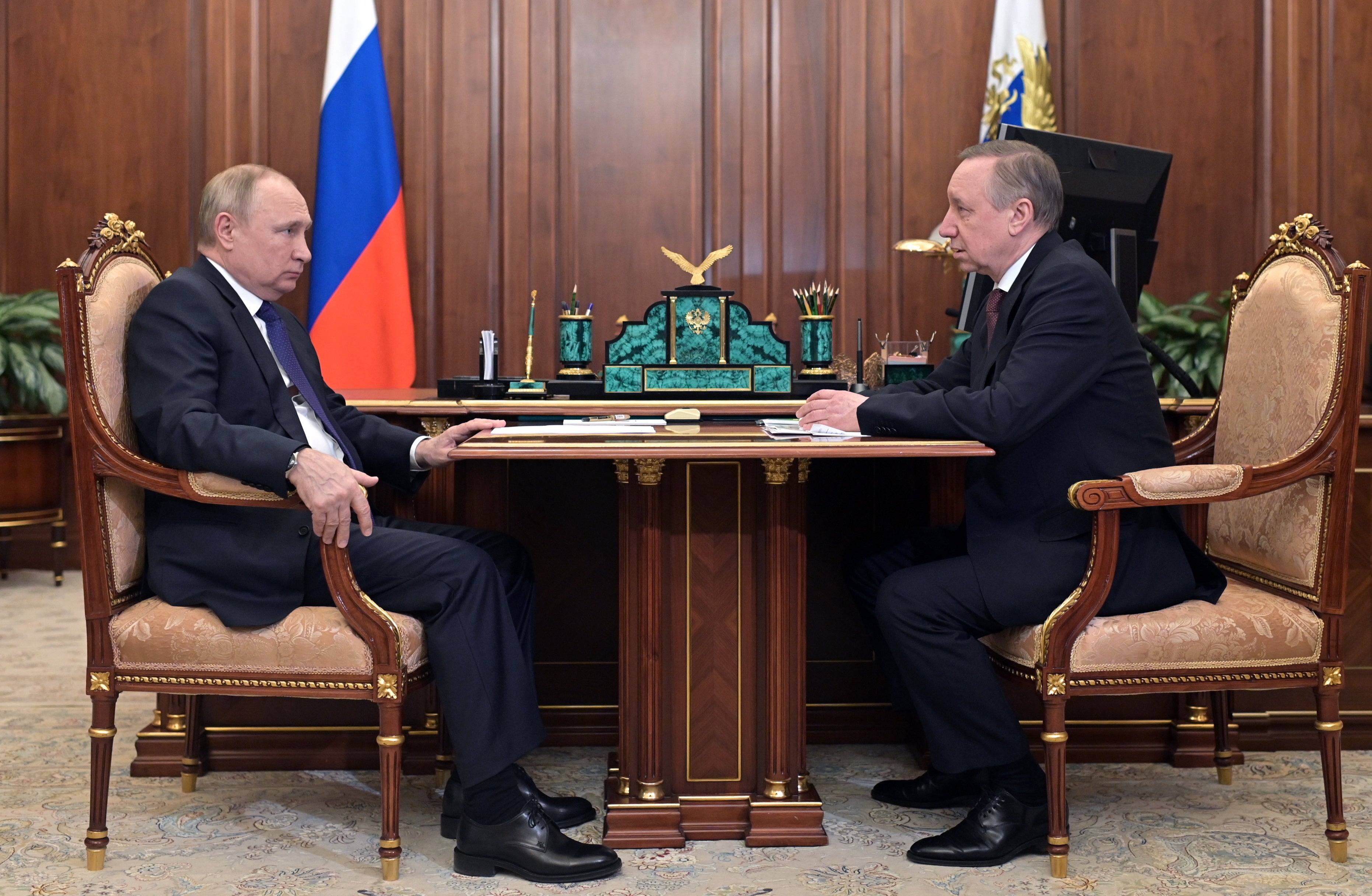 St Petersburg governor Alexander Beglov (R) meets Russian president Vladimir Putin (L) in Moscow on 1 March, 2022