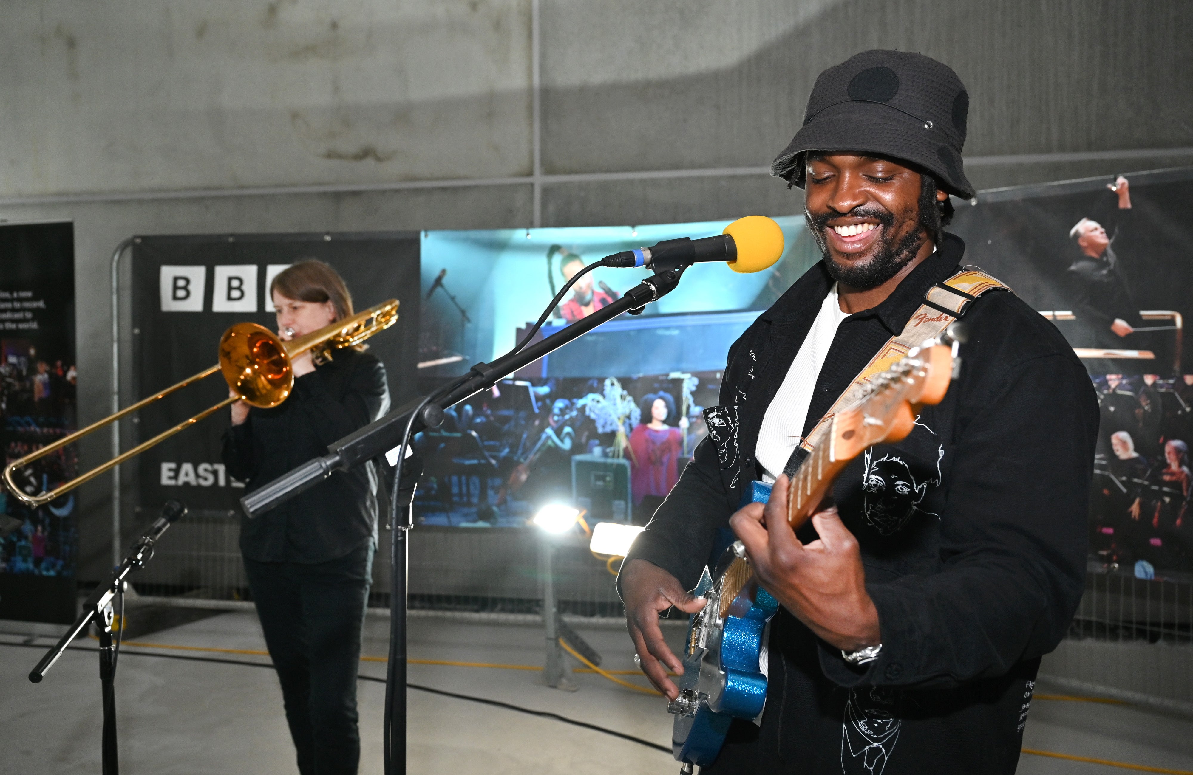 Hak Baker and Helen Vollam celebrate the topping out of the BBC’s new music studios at East Bank, in the first live performance (Mark Allan/BBC/PA)