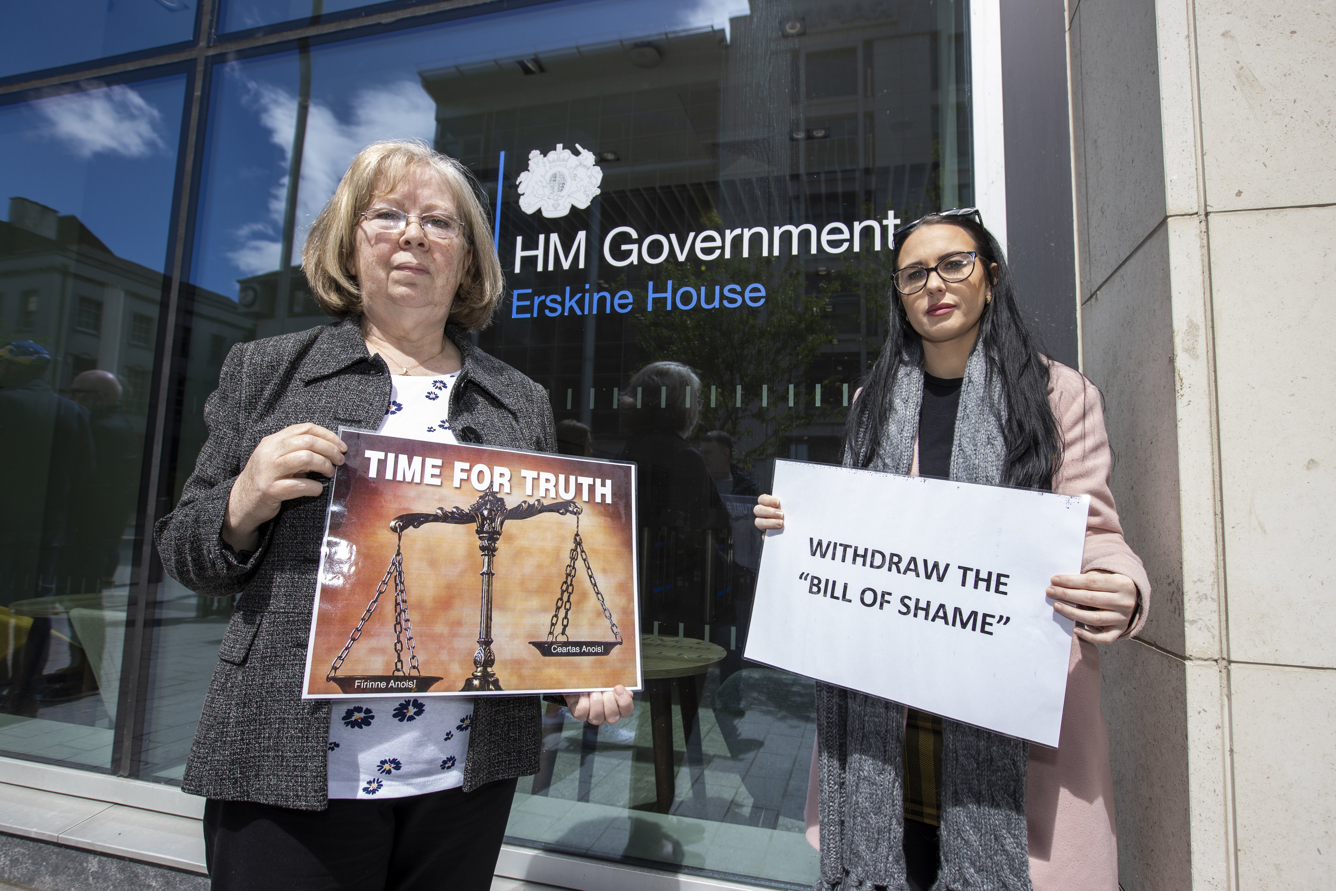 Marian Walsh and Natasha Butler protest at the Northern Ireland Office UK Government Hub at Erskine House in Belfast (PA)