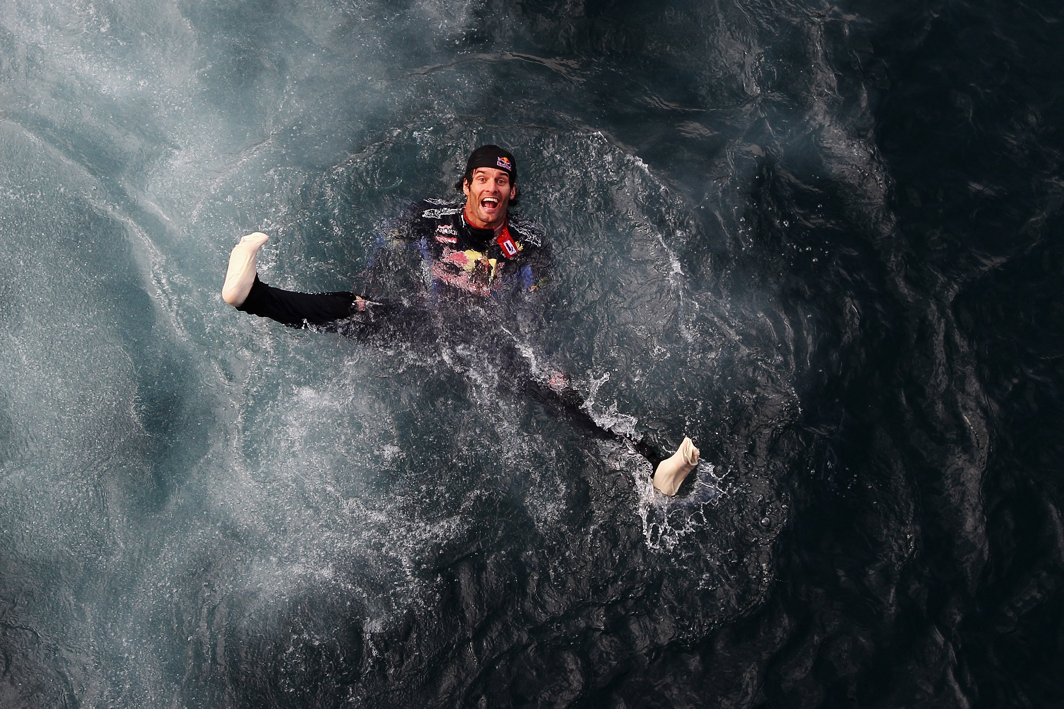 Mark Webber jumps into the harbour after victory in 2010