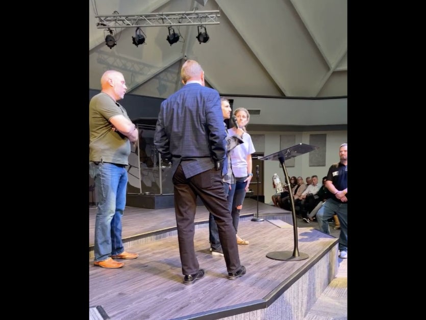 Rev John Lowe II is confronted by a congregant at the New Life Christian Church & World Outreach in Warsaw, Indiana on Sunday