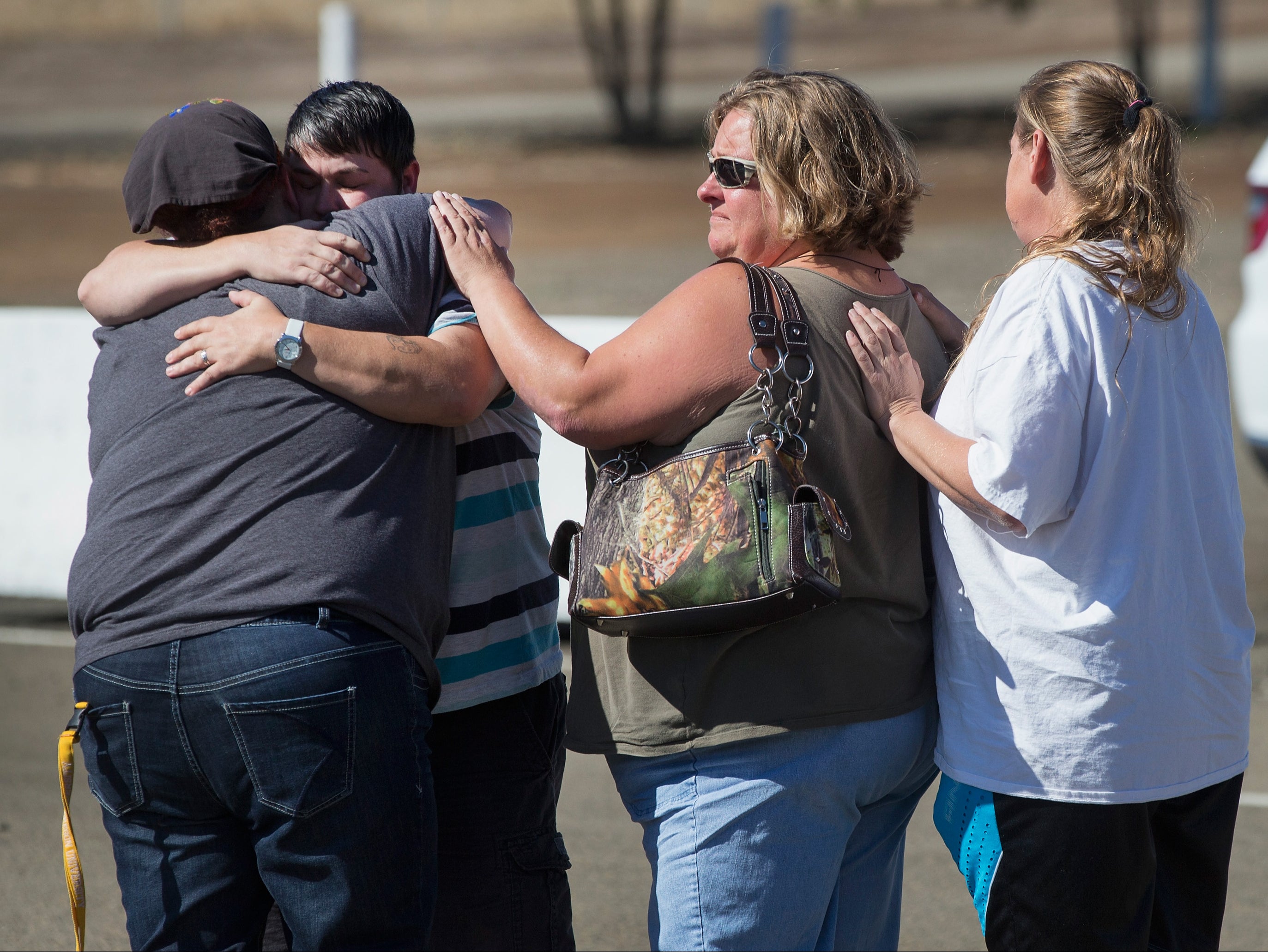 Students and staff of Umpqua Community College console each other following shooting