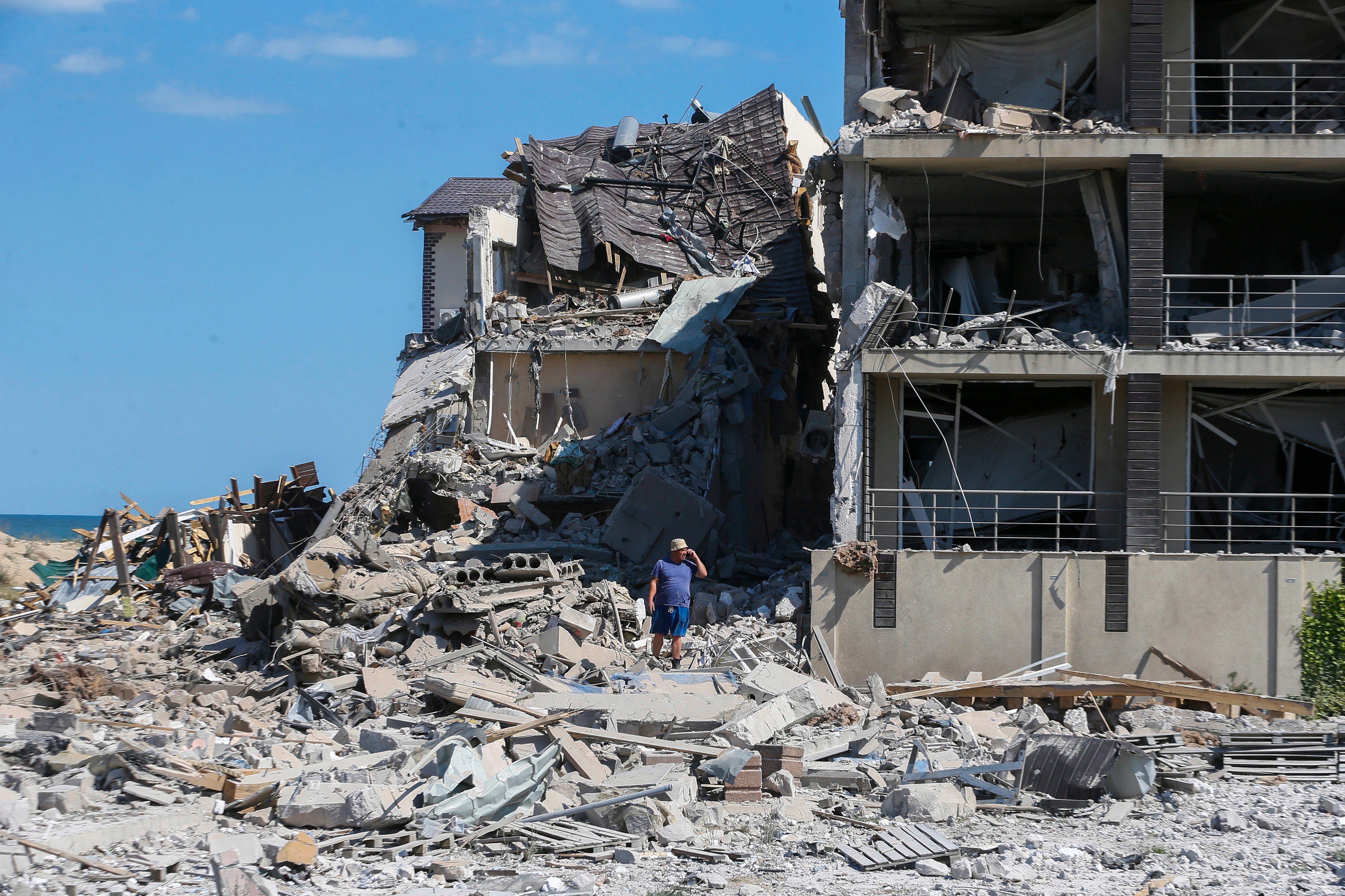 A man inspects the site of a shelling at a tourist resort near Odesa on the Black Sea coast