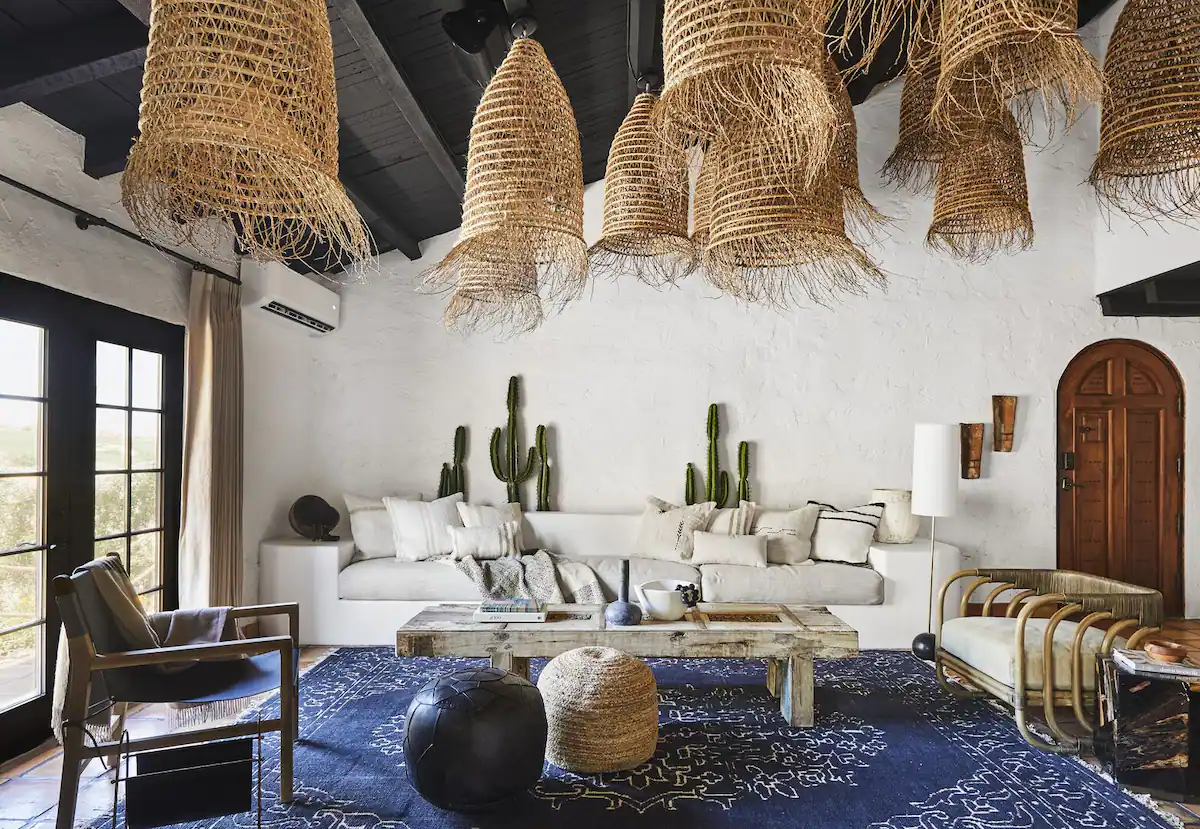 The living room, home to Bobby’s signature earthy tones and black-painted woods