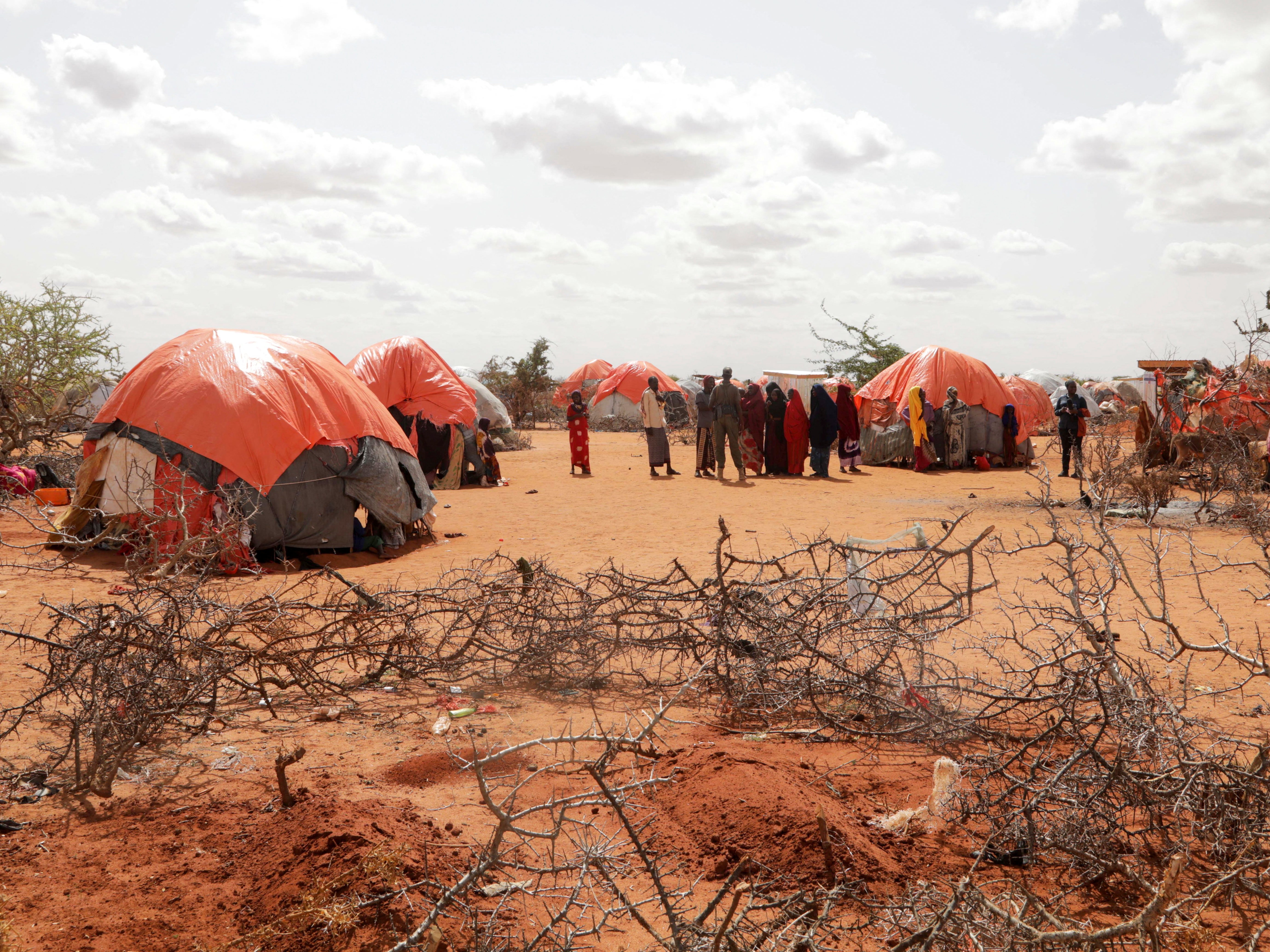 The graves of twin sisters Ebla and Abdia who died of hunger are seen at the Kaxareey camp in Dollow