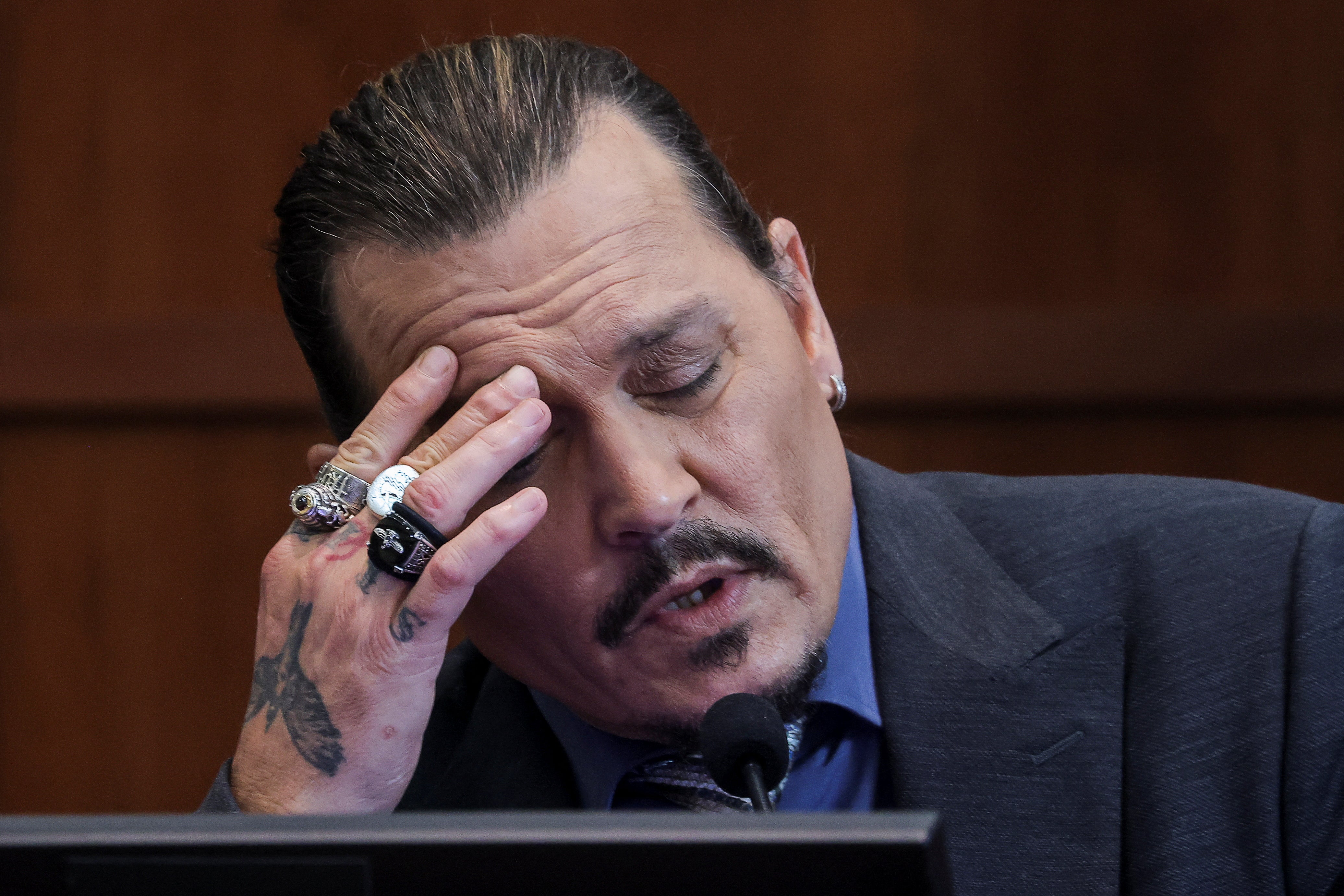 Johnny Depp testifying on the witness stand during his trial