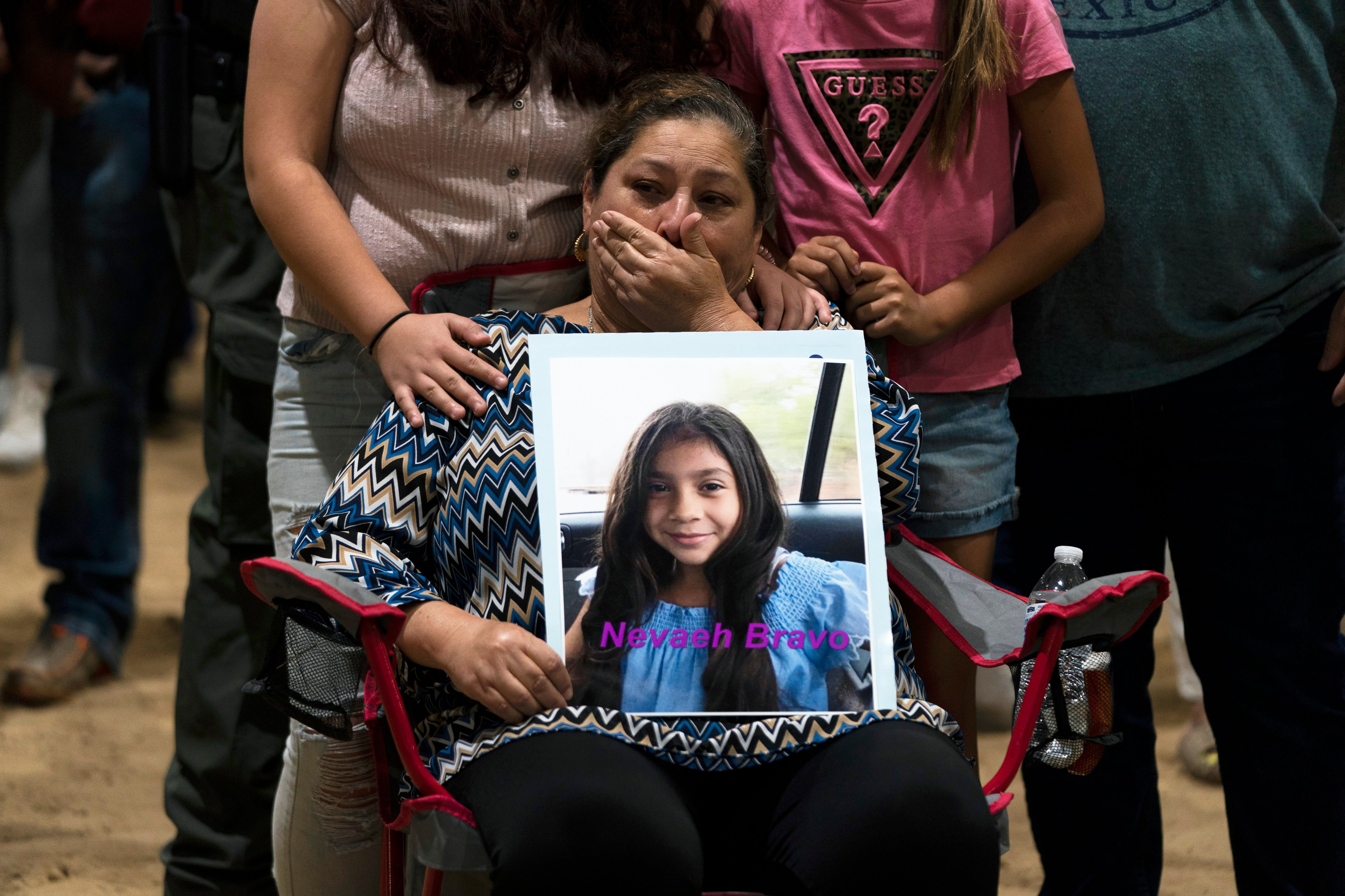 Esmeralda Bravo, 63, sheds tears while holding a photo of her granddaughter, Nevaeh, who was killed