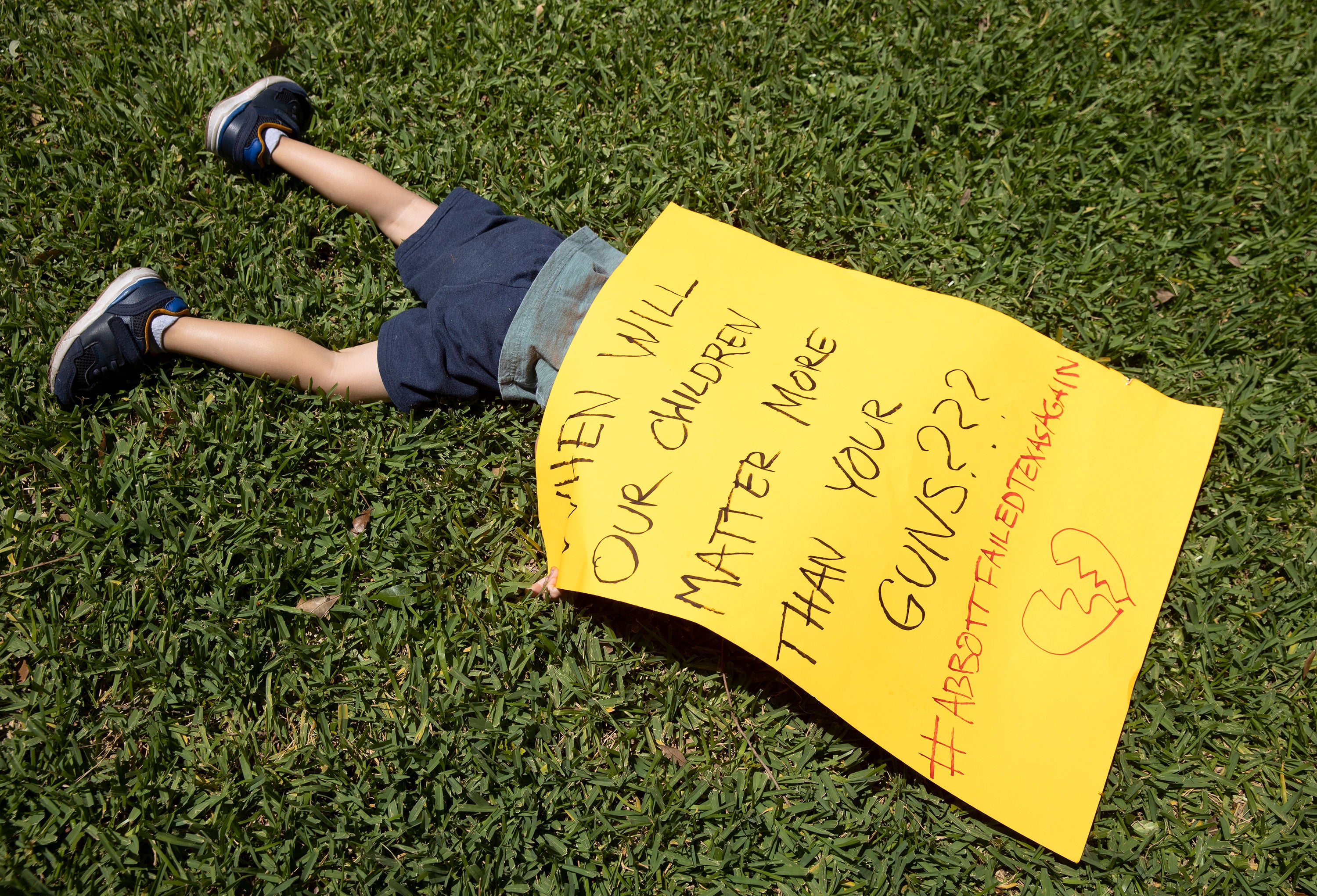 Remy Ragsdale, 3, attends a protest over the massacre organized by Moms Demand Action on Wednesday May 25, 2022