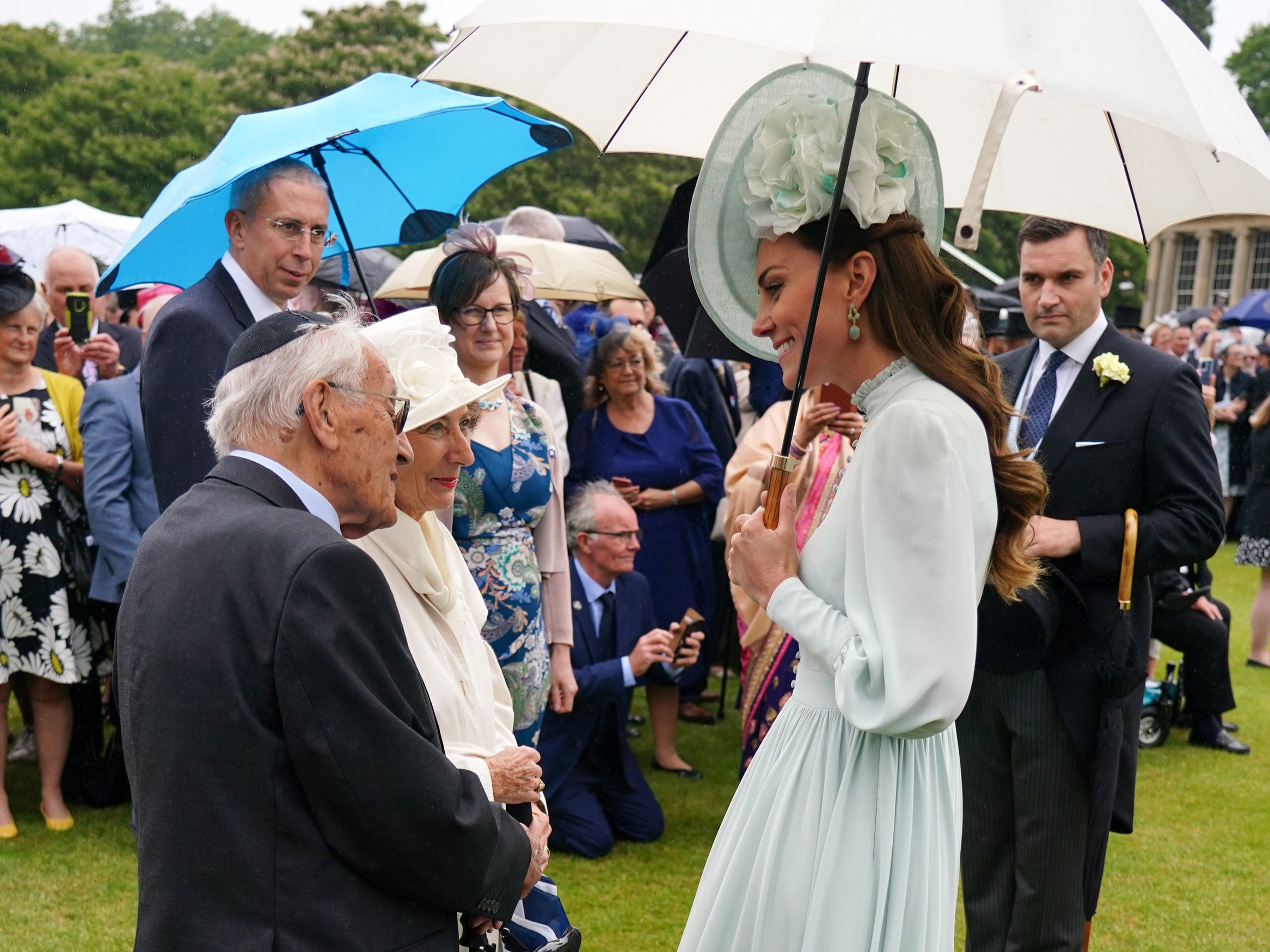 The Duchess of Cambridge meeting guests during a Royal Garden Party at Buckingham Palace in London