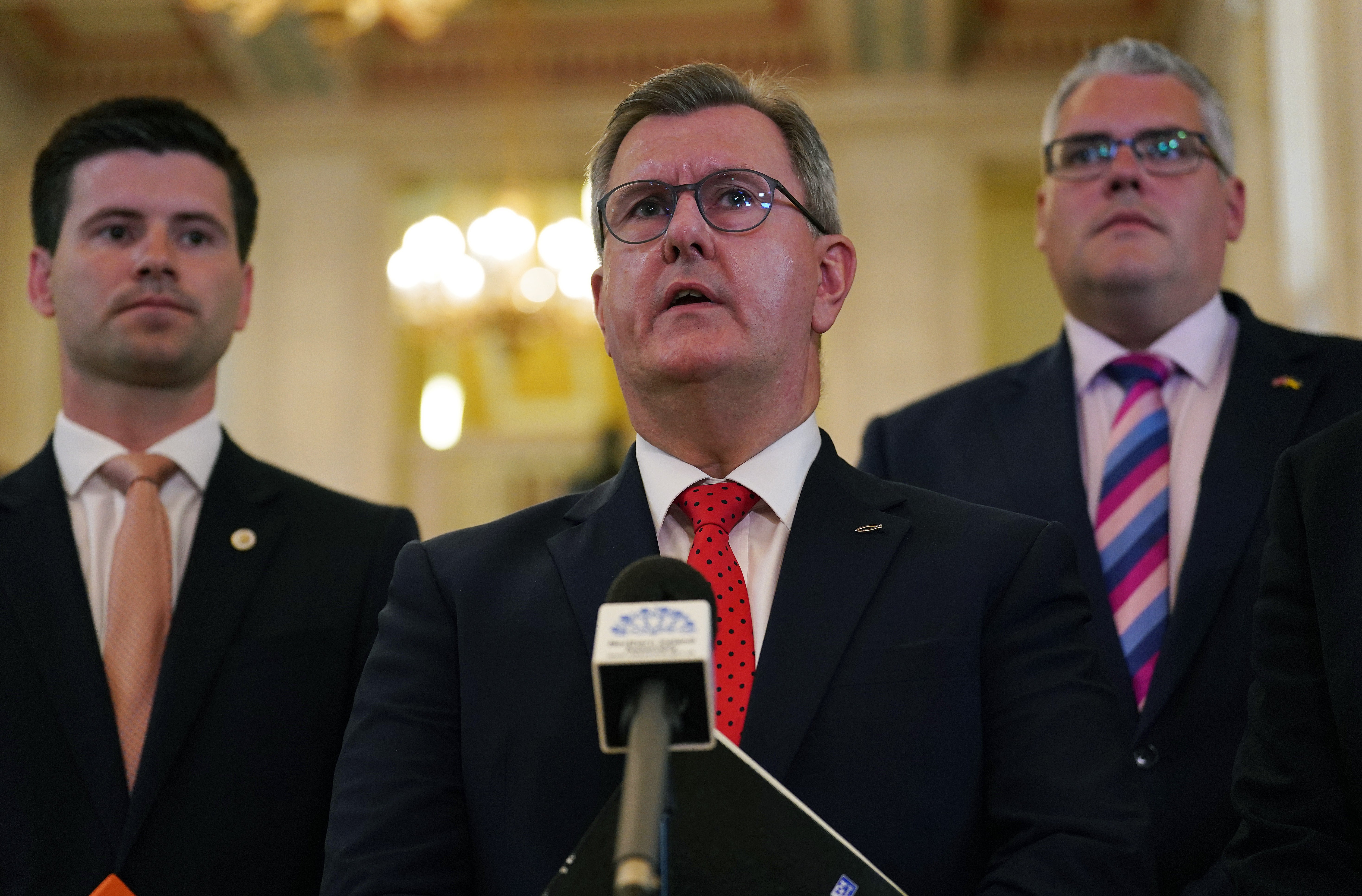 DUP leader Jeffrey Donaldson (centre) speaking to the media at Stormont