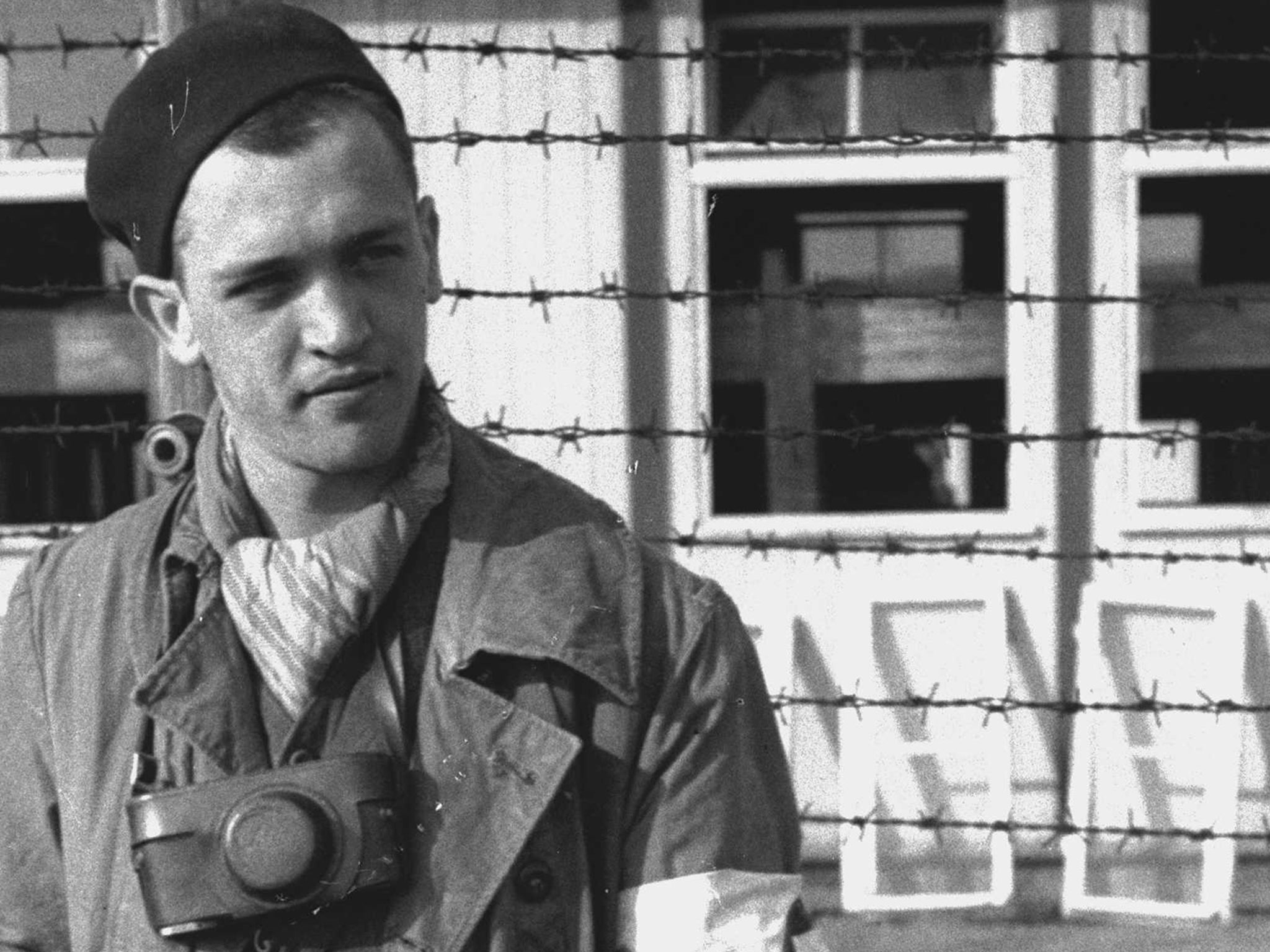 Portrait of Francesc Boix wearing a beret and a Leica camera