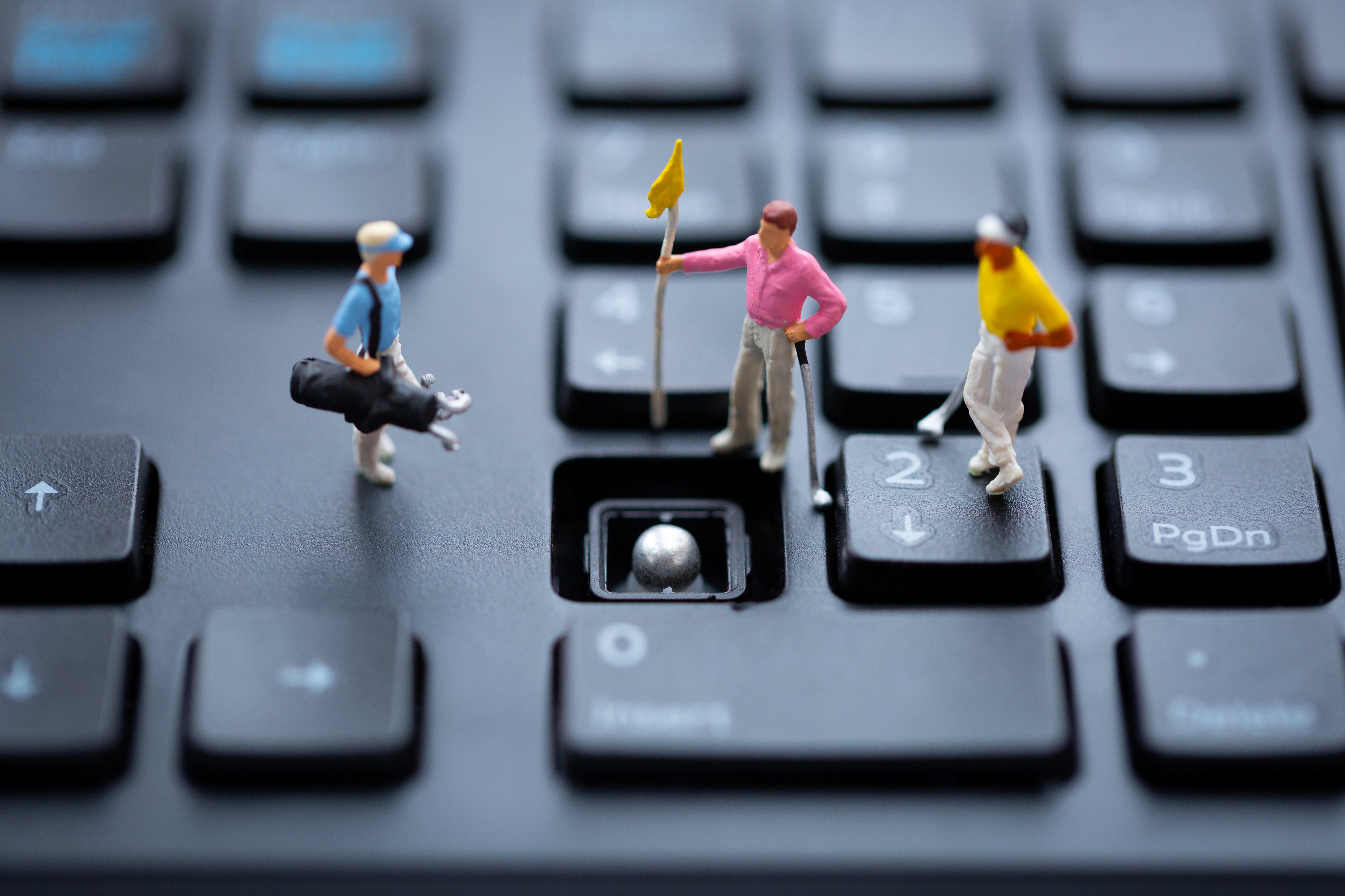 Golfers use a keyboard for a putting green