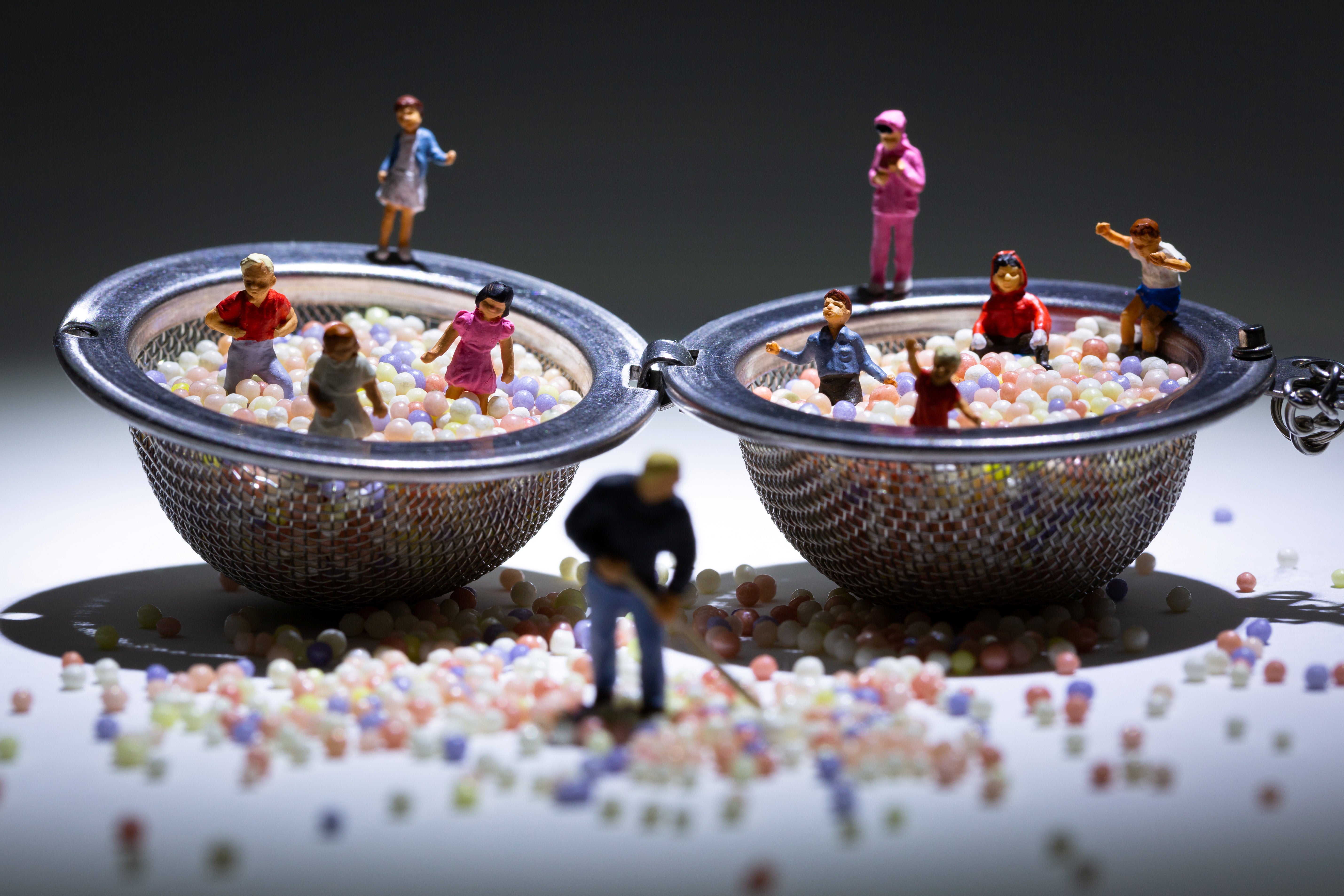 Figures of children playing in ball pits