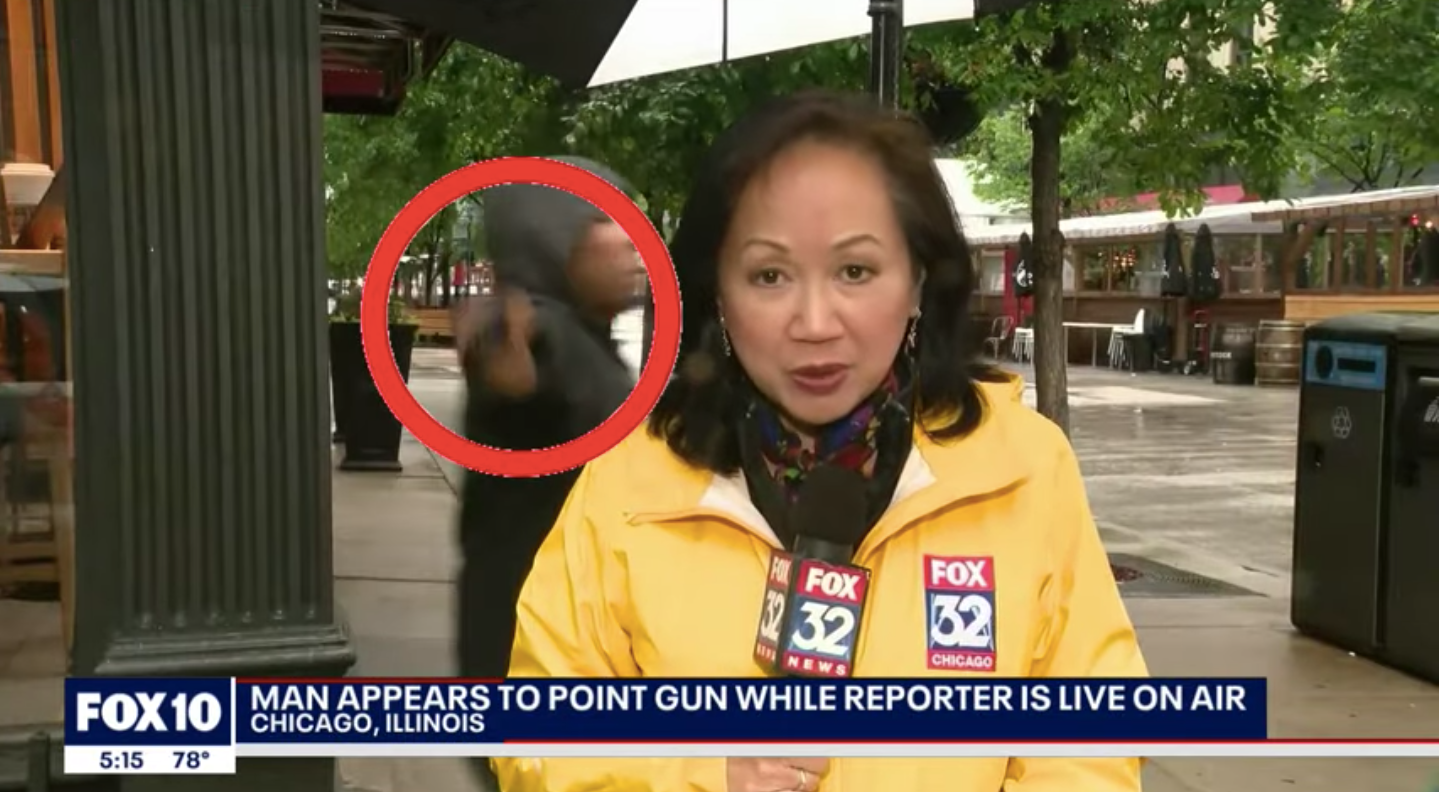 The moment a man appeared to pull a gun in front of a Fox News TV crew is caught on camera.