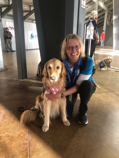 Bonnie Fear, from Colorado, is the K-9 Crisis Response Coordinator for Lutheran Church Charities; she poses with Joy, one of several golden retrievers brought in to comfort the the Uvalde community