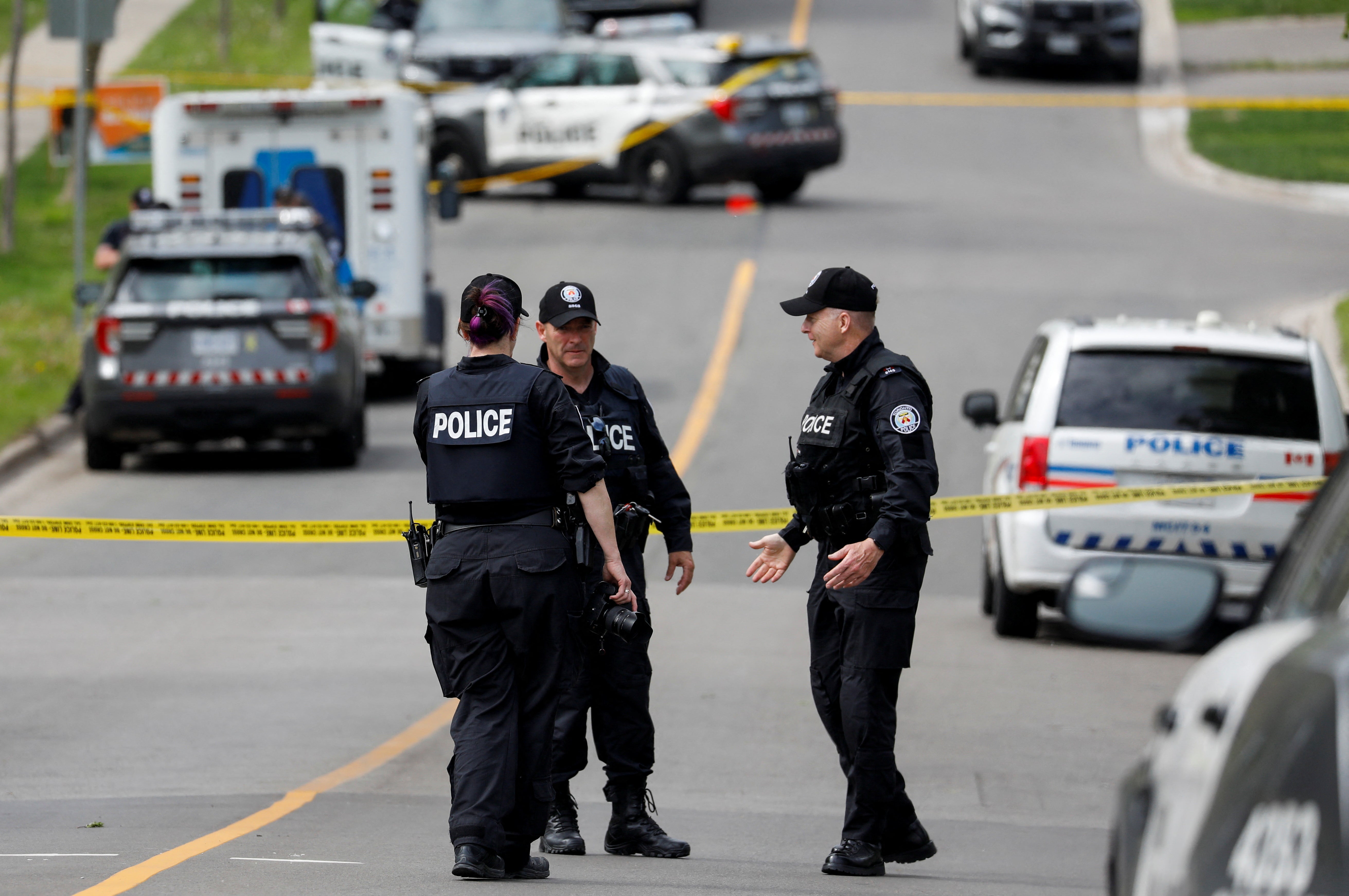 Tornoto police at the scene where officers shot dead a suspect who was walking down a street carrying a gun