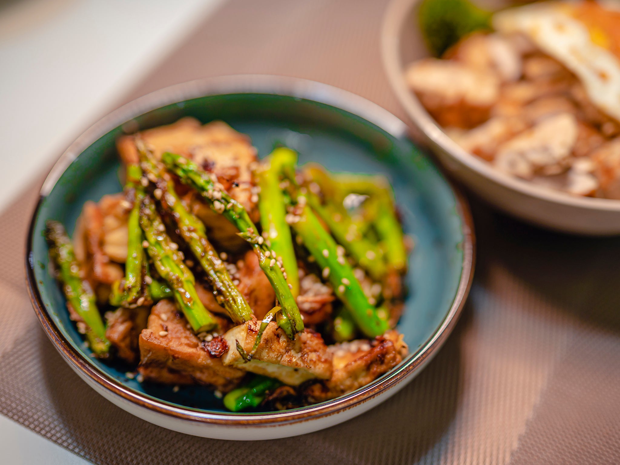 This fast, one-pan stir-fry dinner combines vibrant spring vegetables with hearty tofu in a rich and spicy black-pepper sauce