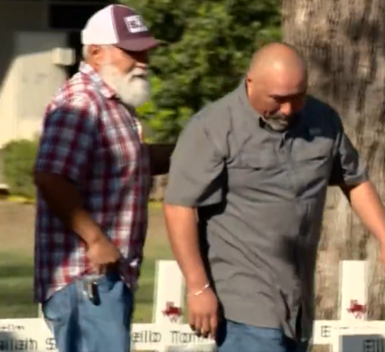 Mr Garcia (R) placing flowers at a memorial to his wife hours before dying of a heart attack