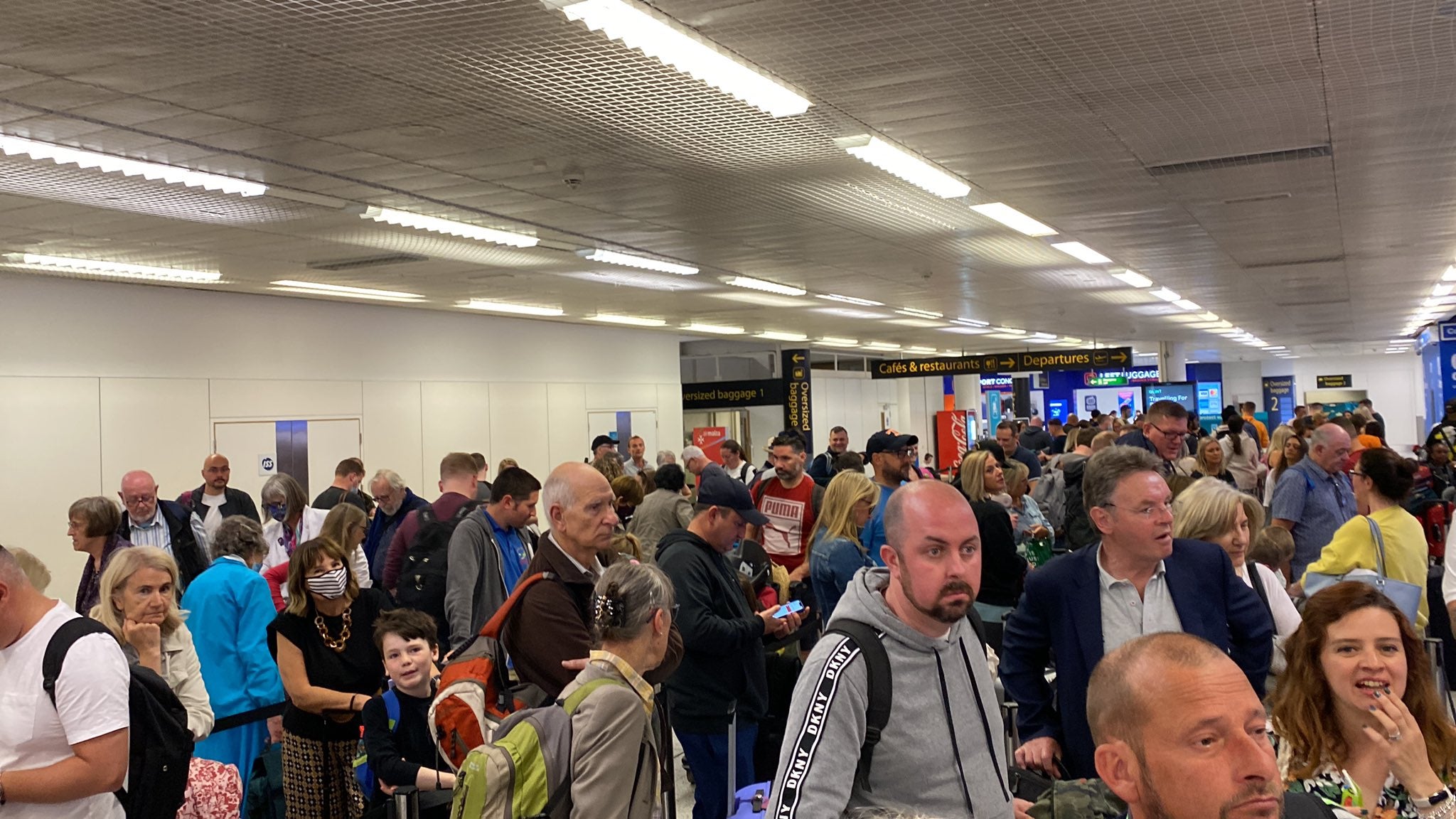 Air Malta passengers waiting during a delay at Gatwick on Friday