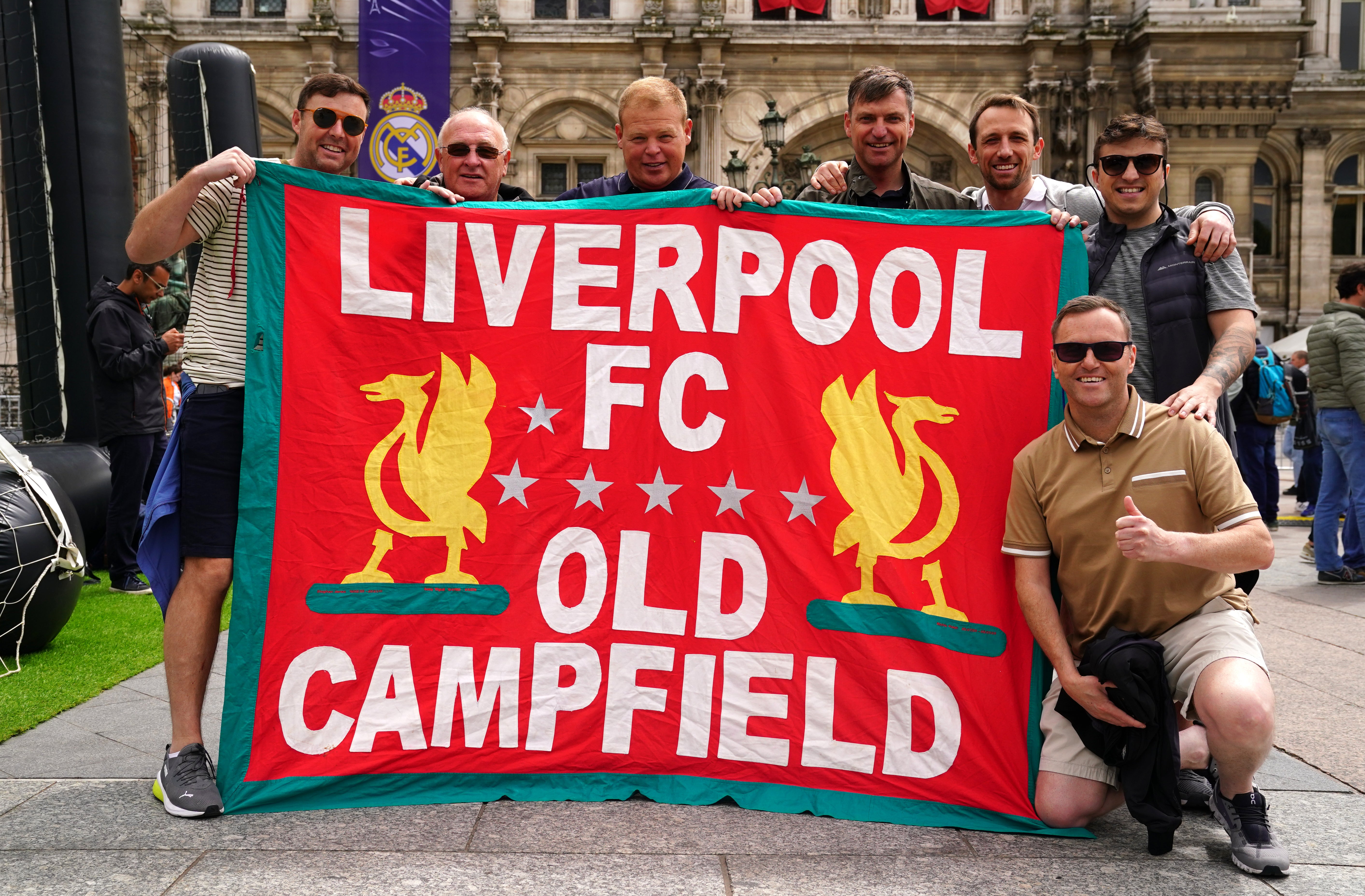 Liverpool fans hold a flag of support at the Trophy Experience at The Place de l’Hotel de Ville in Paris ahead of Saturday’s UEFA Champions League Final at the Stade de France, Paris (Adam Davy/PA)