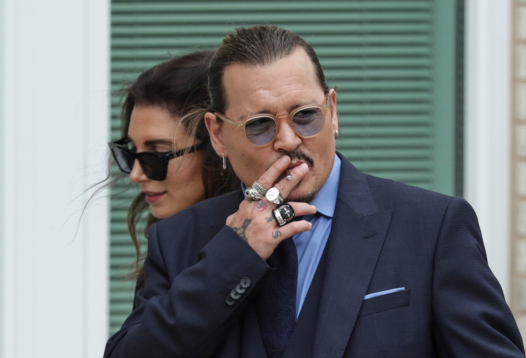 Johnny Depp smokes during a break in his trial at the Fairfax County Courthouse on Friday