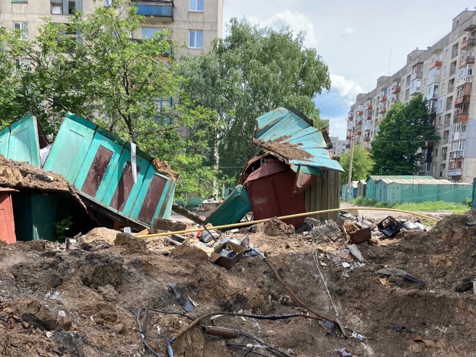 A hole in the ground where a Russian missile hit near a residential block in Luhansk, eastern Ukraine