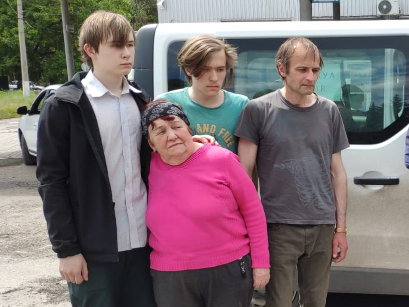 Vera Ivanova, 73, whose daughter Nataliya was killed by Russian shelling, with her grieving twin grandsons Maxim and Oleksandr, 14, and son-in-law Vladislav