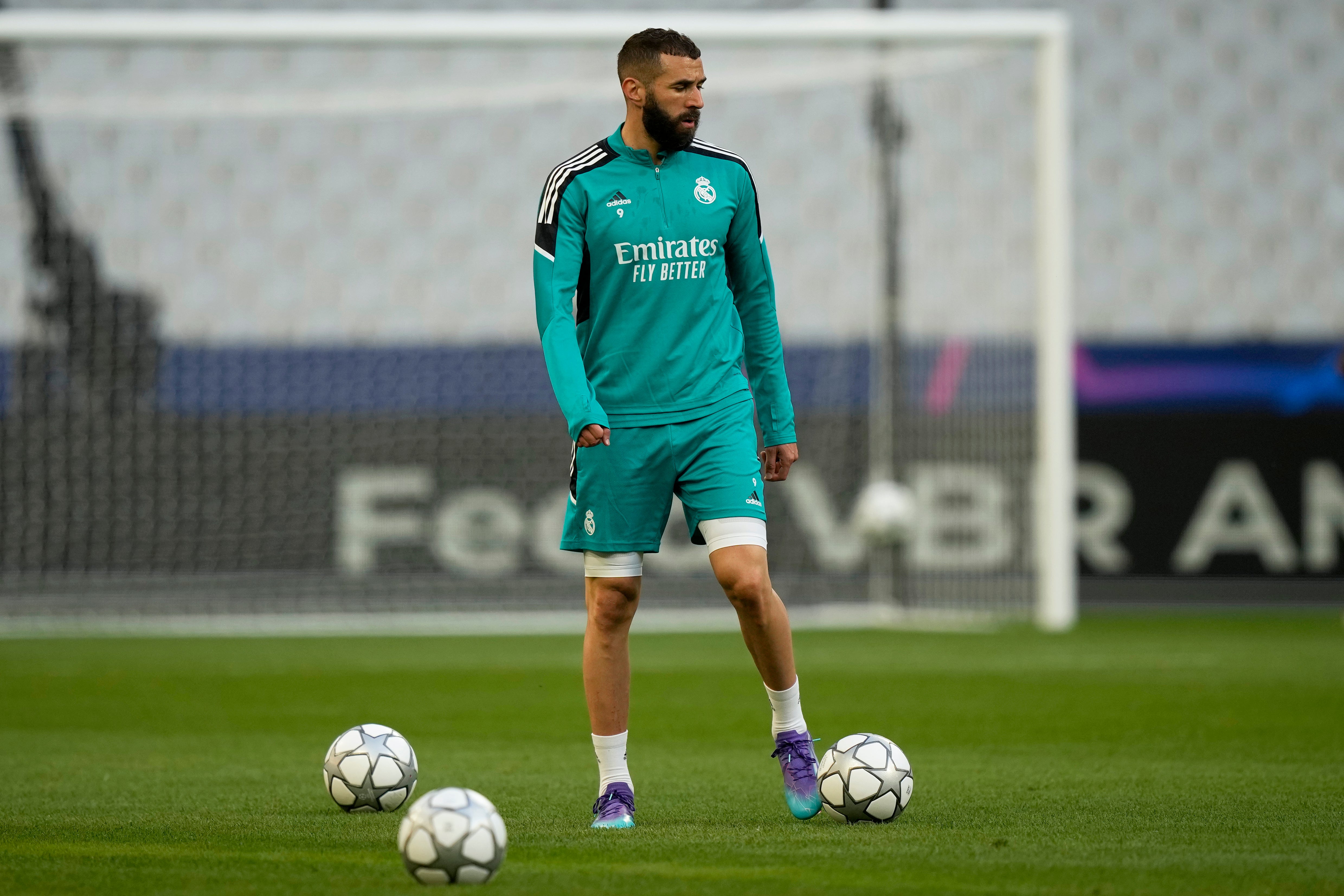 Karim Benzema plays with a ball during a training session