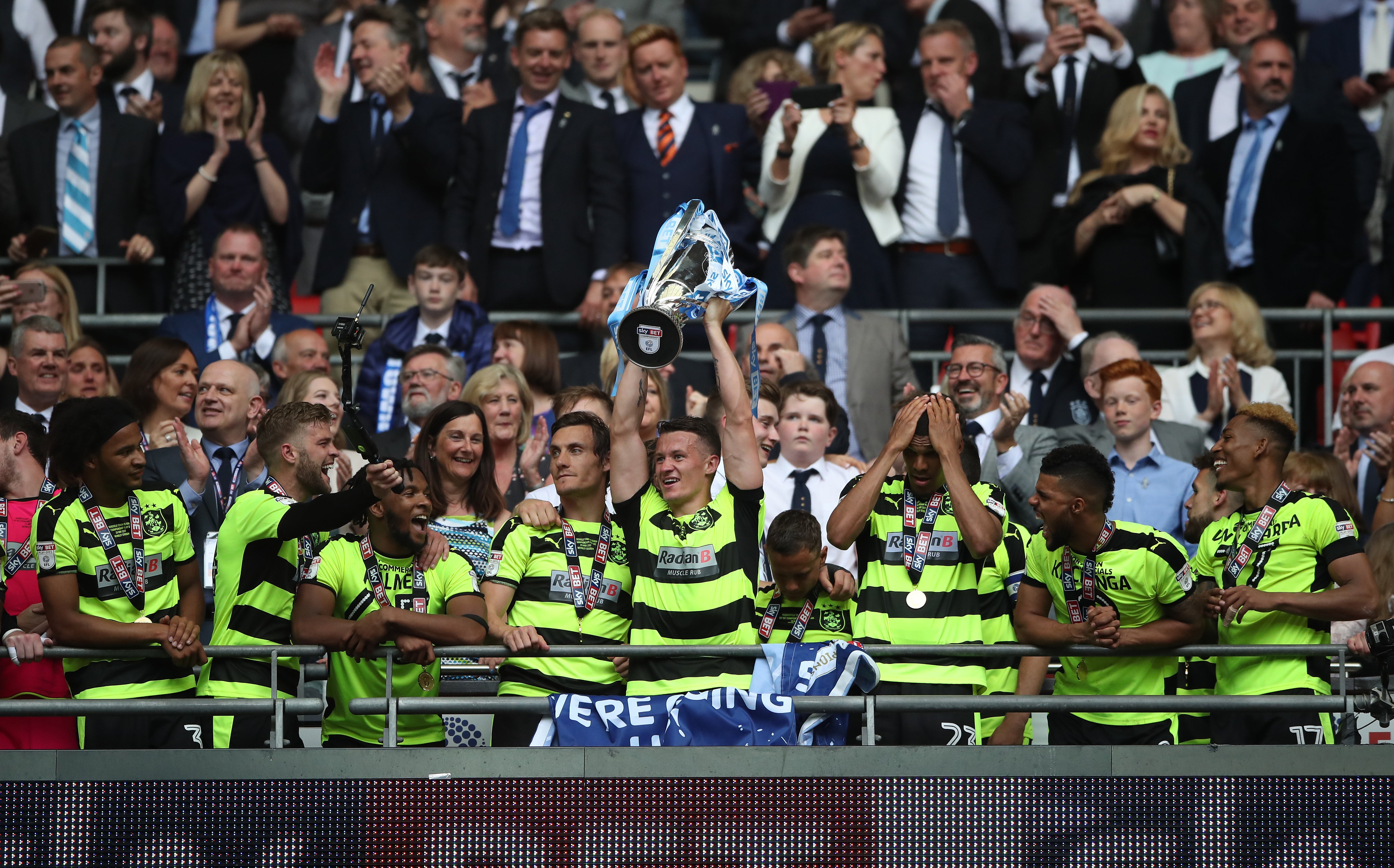 Jonathan Hogg (raising trophy) hopes to celebrate another Premier League promotion with Huddersfield (Nick Potts/PA)