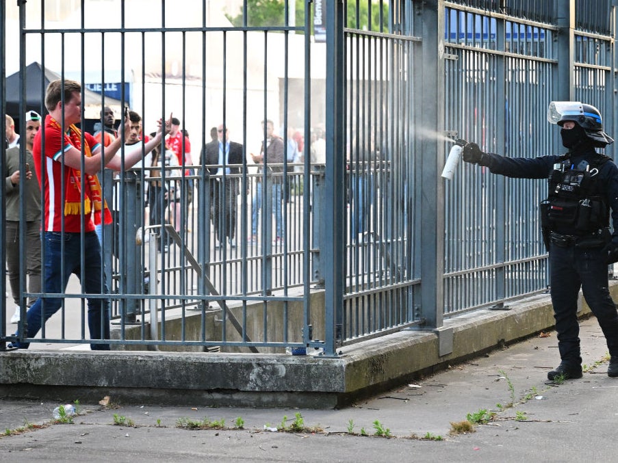 Police spray tear gas at Liverpool fans outside the stadium