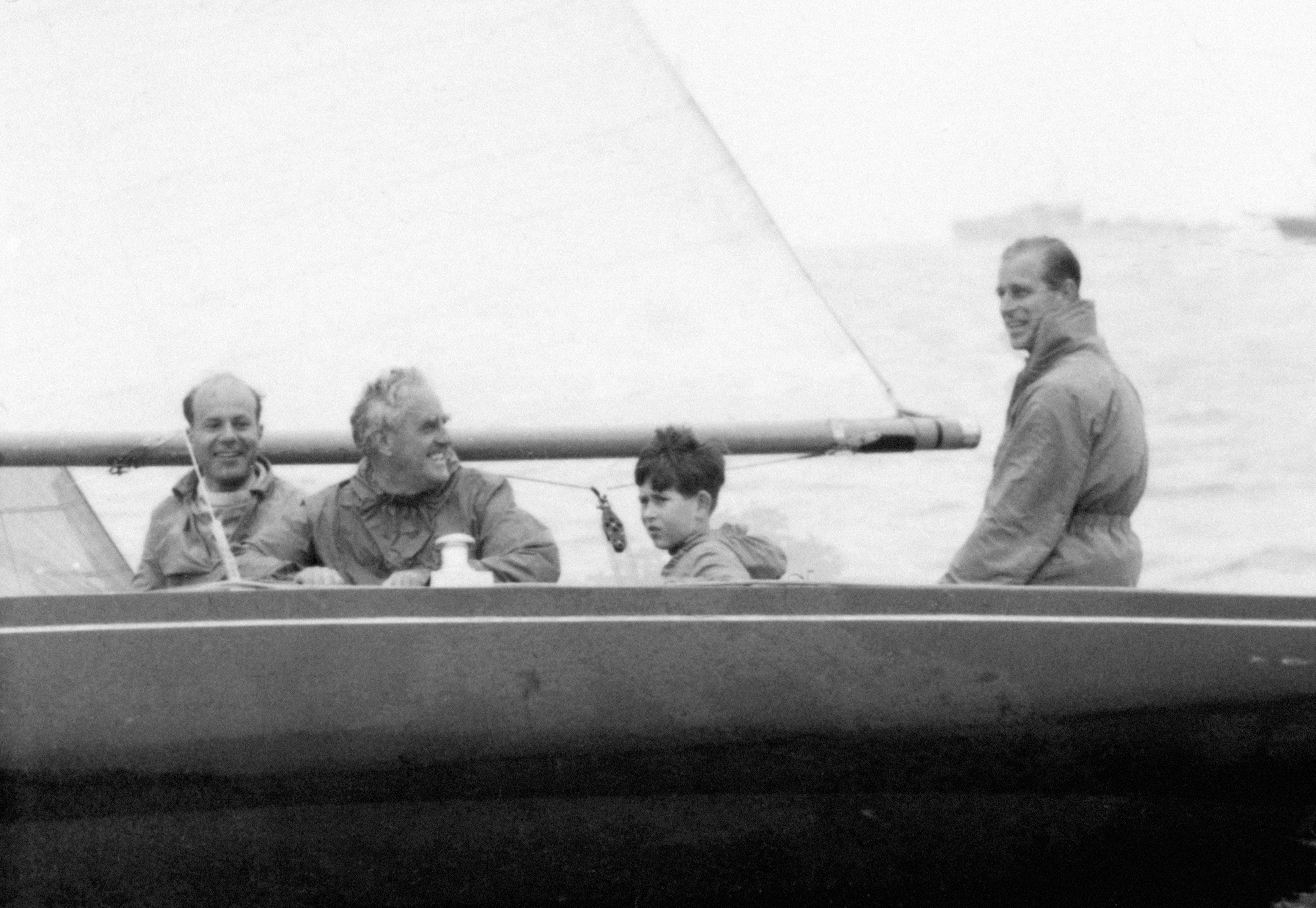 A young Prince Charles on board the Dragon class yacht Bluebottle, with his father, the Duke of Edinburgh (PA)