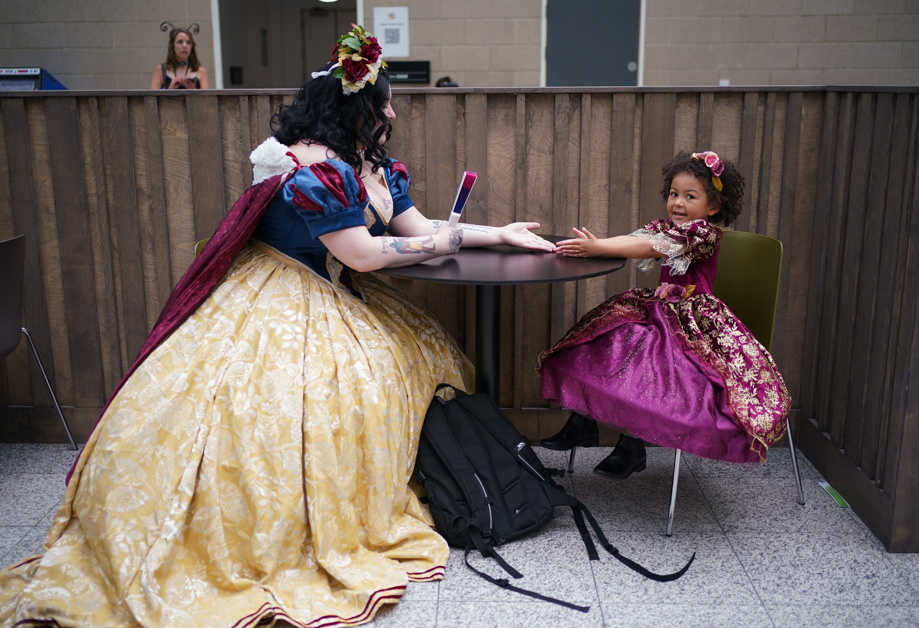 Mother and daughter cosplayers Revan Jordan, left, dressed as Snow White, and Bella, dressed as Rapunzel, during MCM Comic Con at the ExCel in London (Yui Mok/PA)