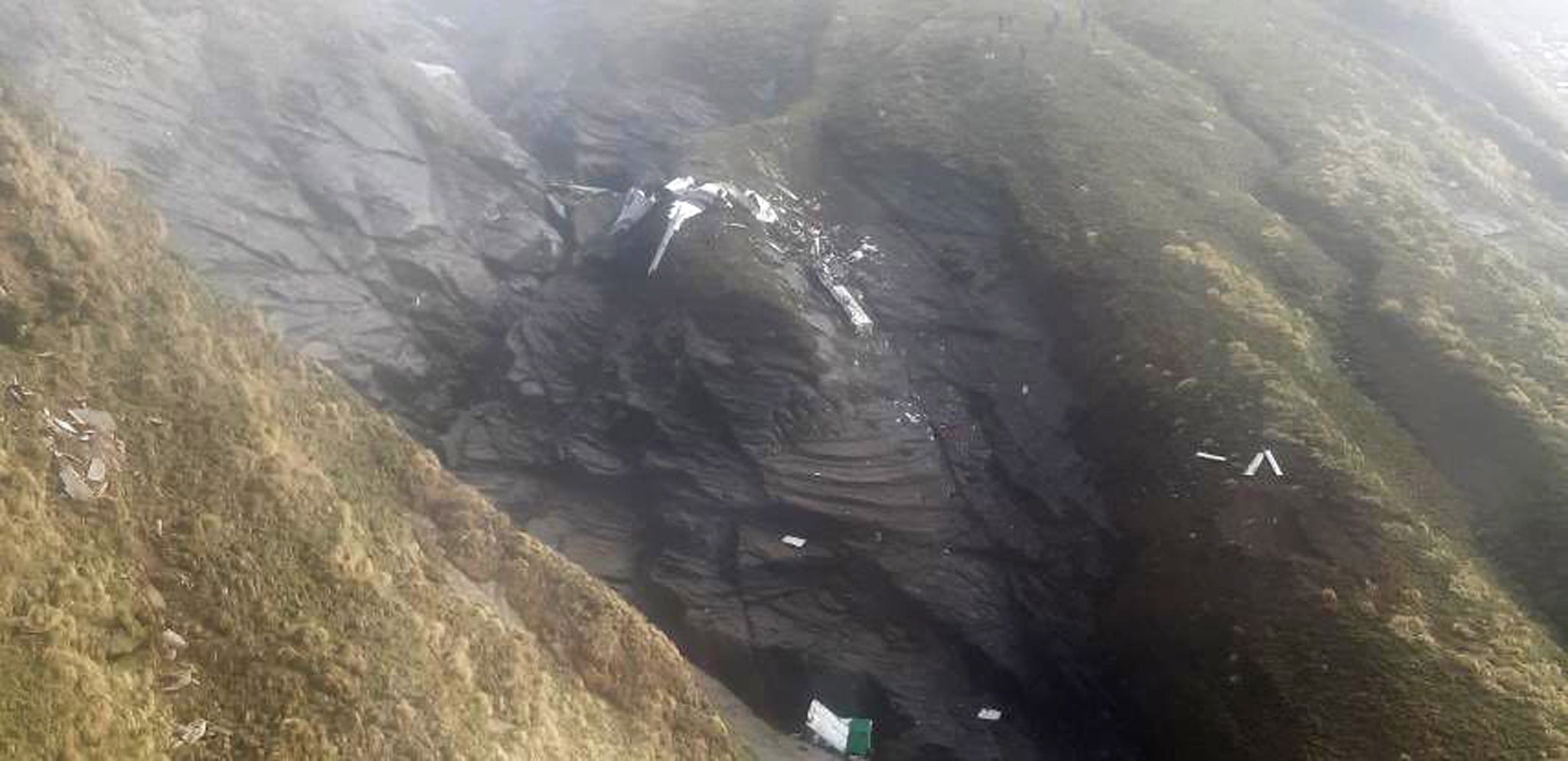 The crash site of a Tara Air twin engine plane on a cliff at Thasang Village