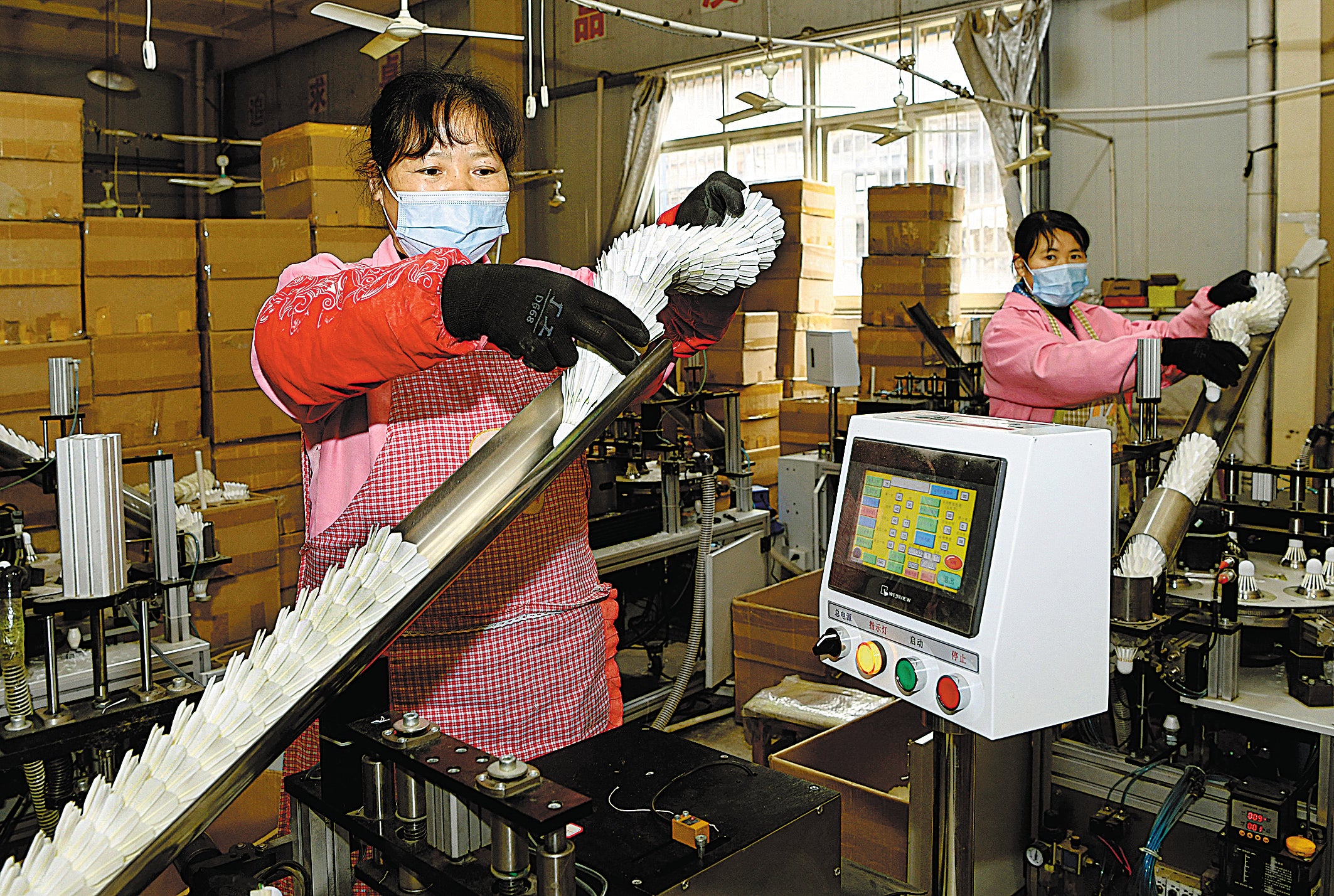 Villagers work in the badminton shuttlecock production workshop of a feather processing company in Shucheng county, Lu’an, in March 2022