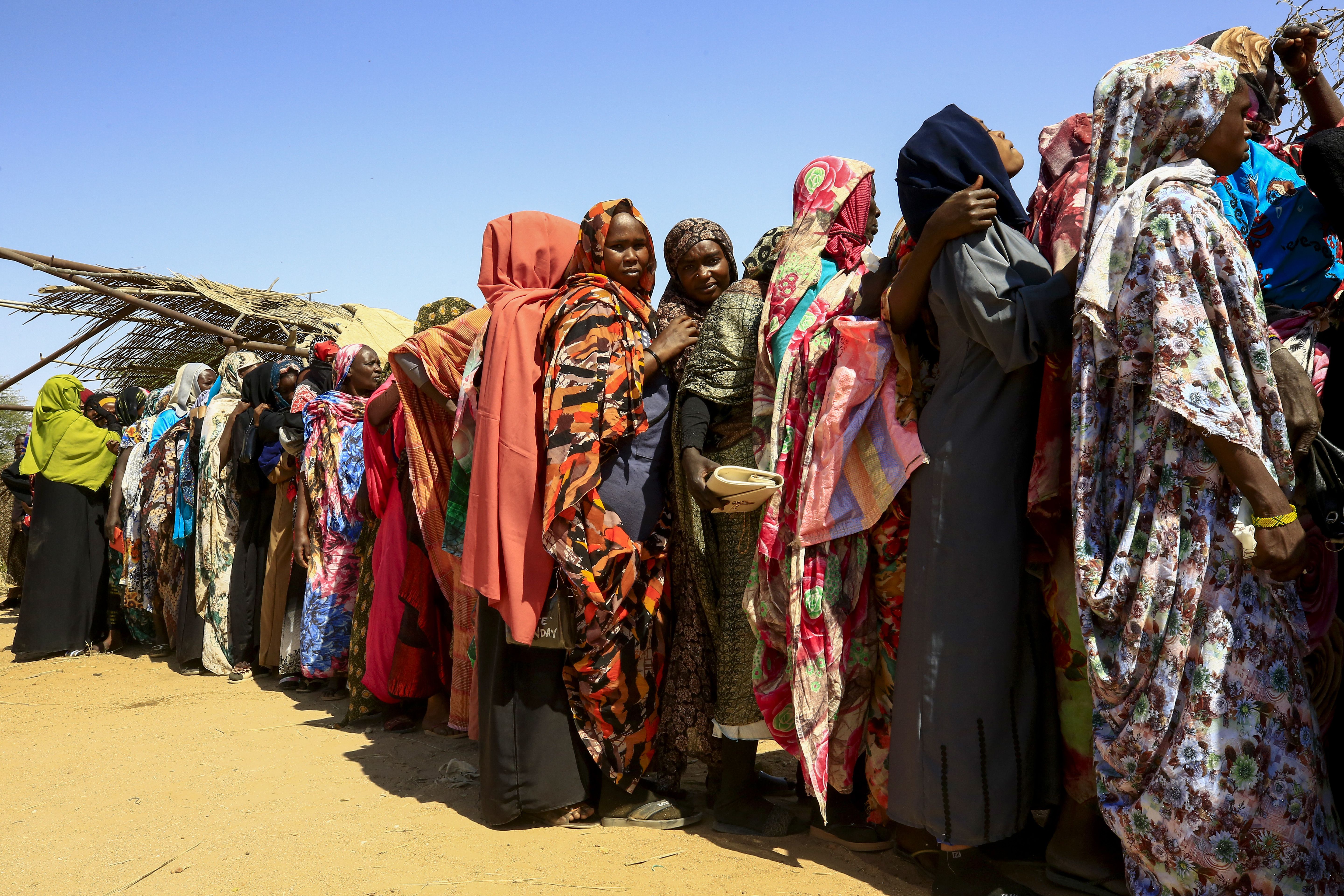 Refugees from Darfur, western Sudan, wait for the arrival of the World Food Programme