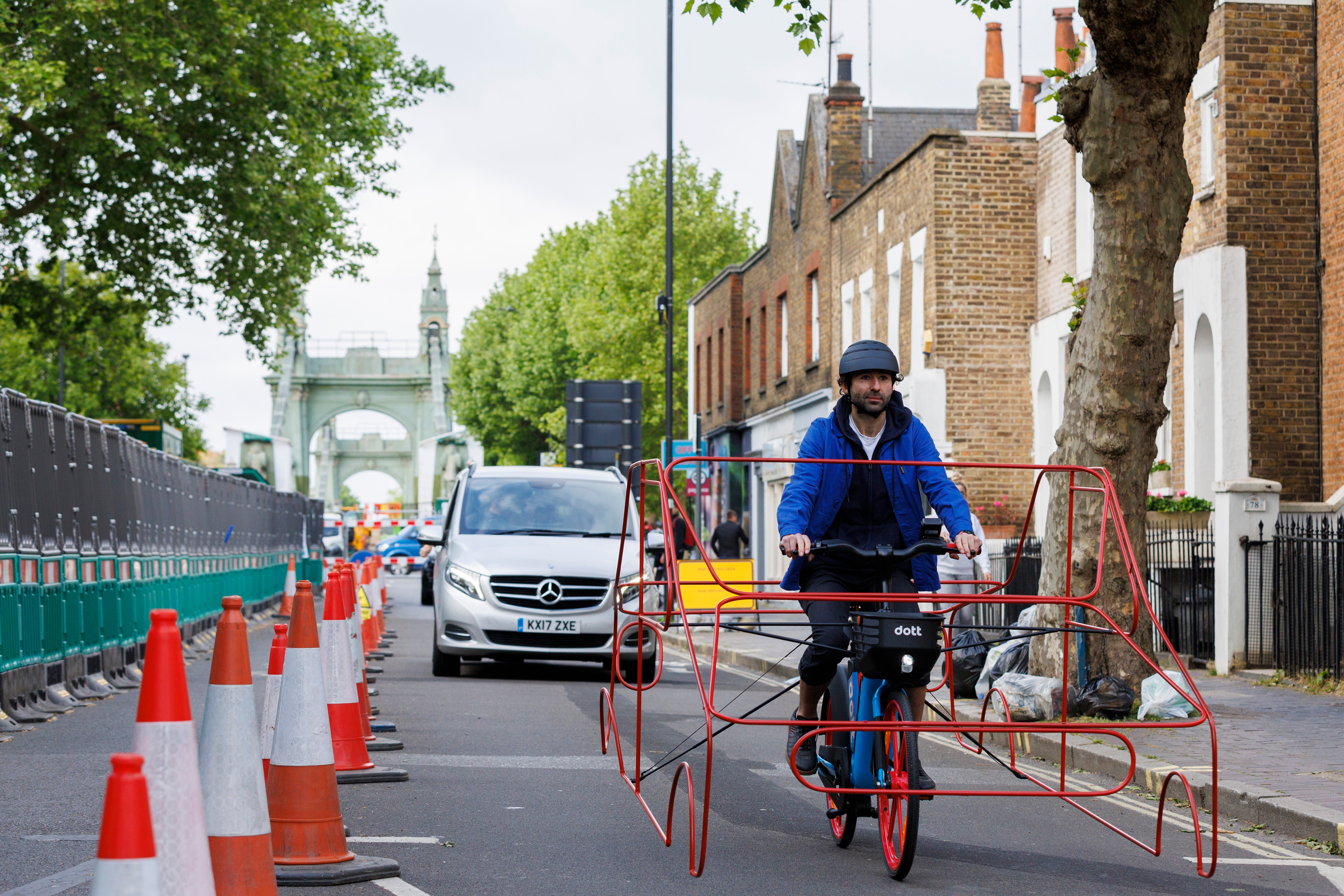 Cyclists wearing frames shaped like cars are taking to the streets of London to demonstrate that vehicles are ‘hogging’ roads (Dott/PA)