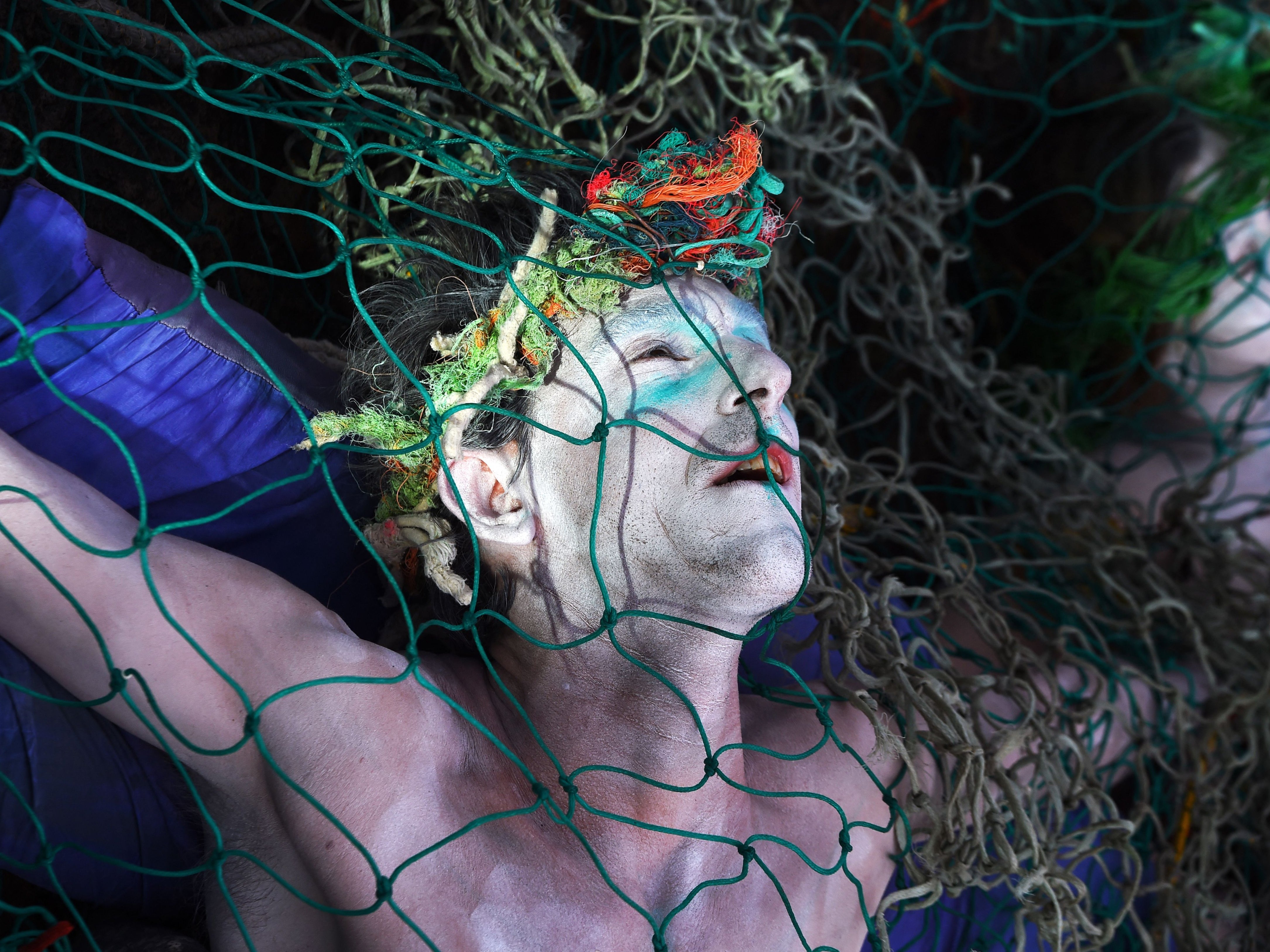 Ocean Rebellion activists stage a protest against bottom trawling fishing near the Scottish Event Centre (SEC) in Glasgow ahead of Cop26