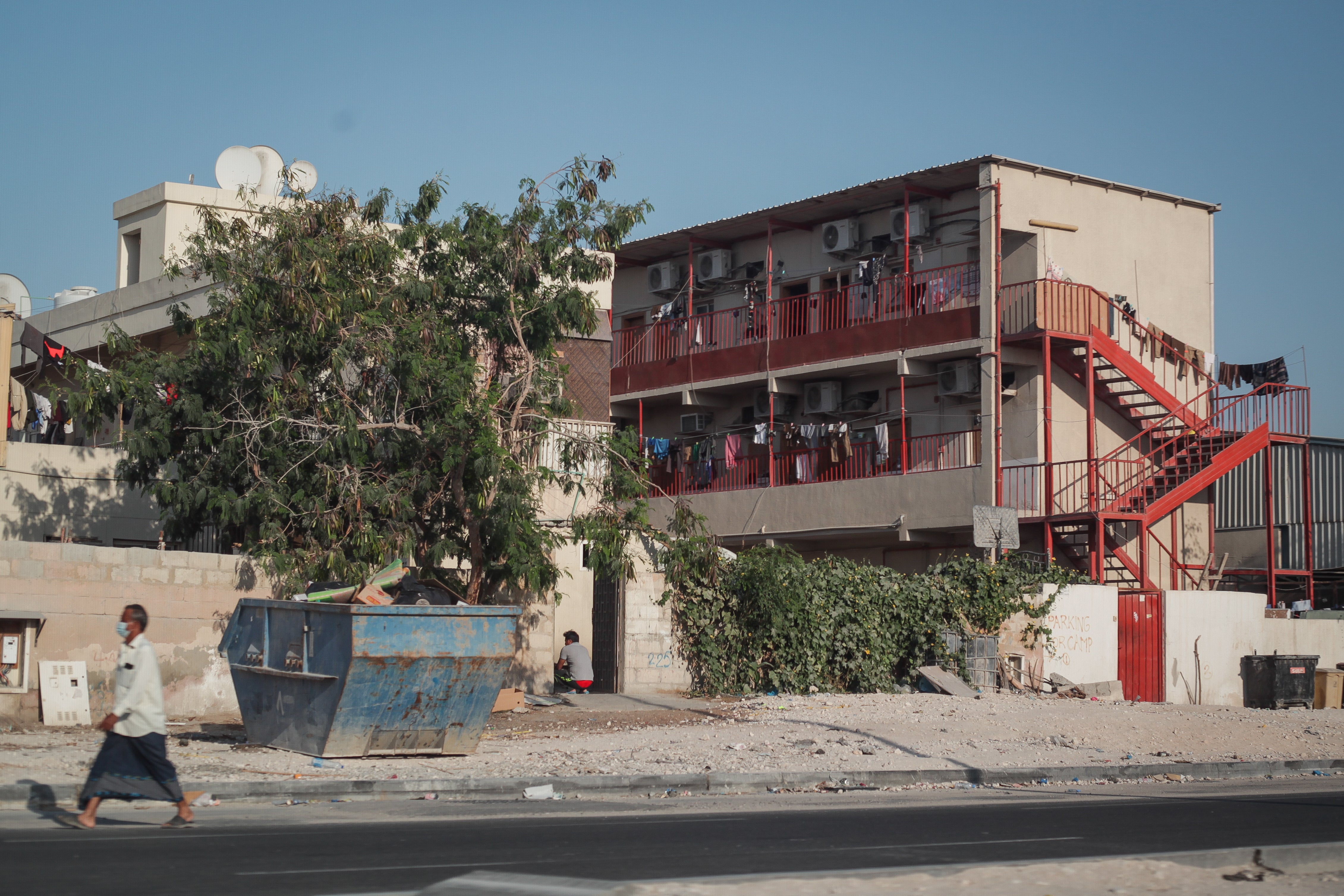 A man walks past an accommodation block in the Industrial Area