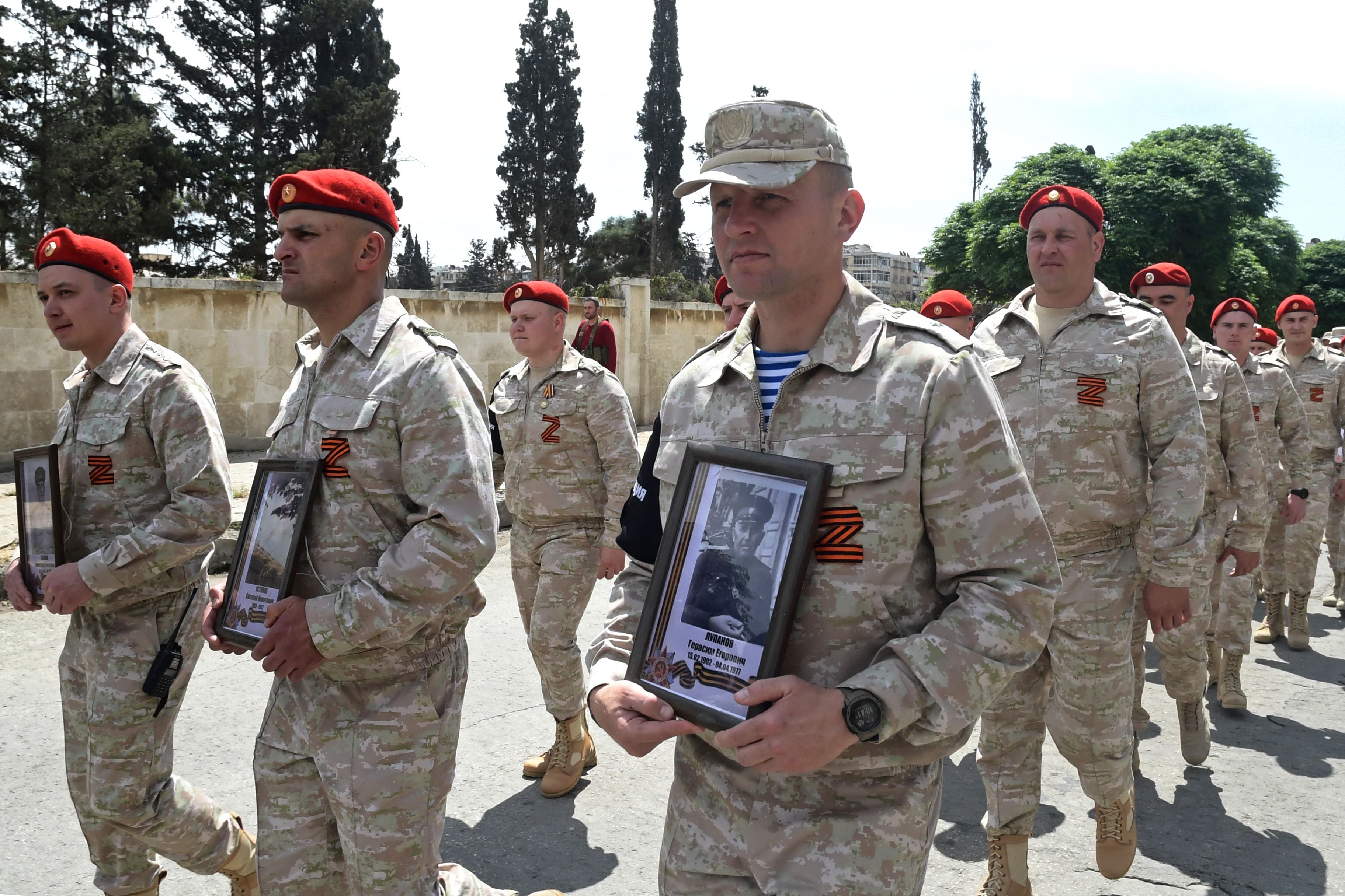 Russian military personnel, wearing a symbol “Z” in the colours of the Saint George ribbon, march during the Victory Day parade in Aleppo on 9 May