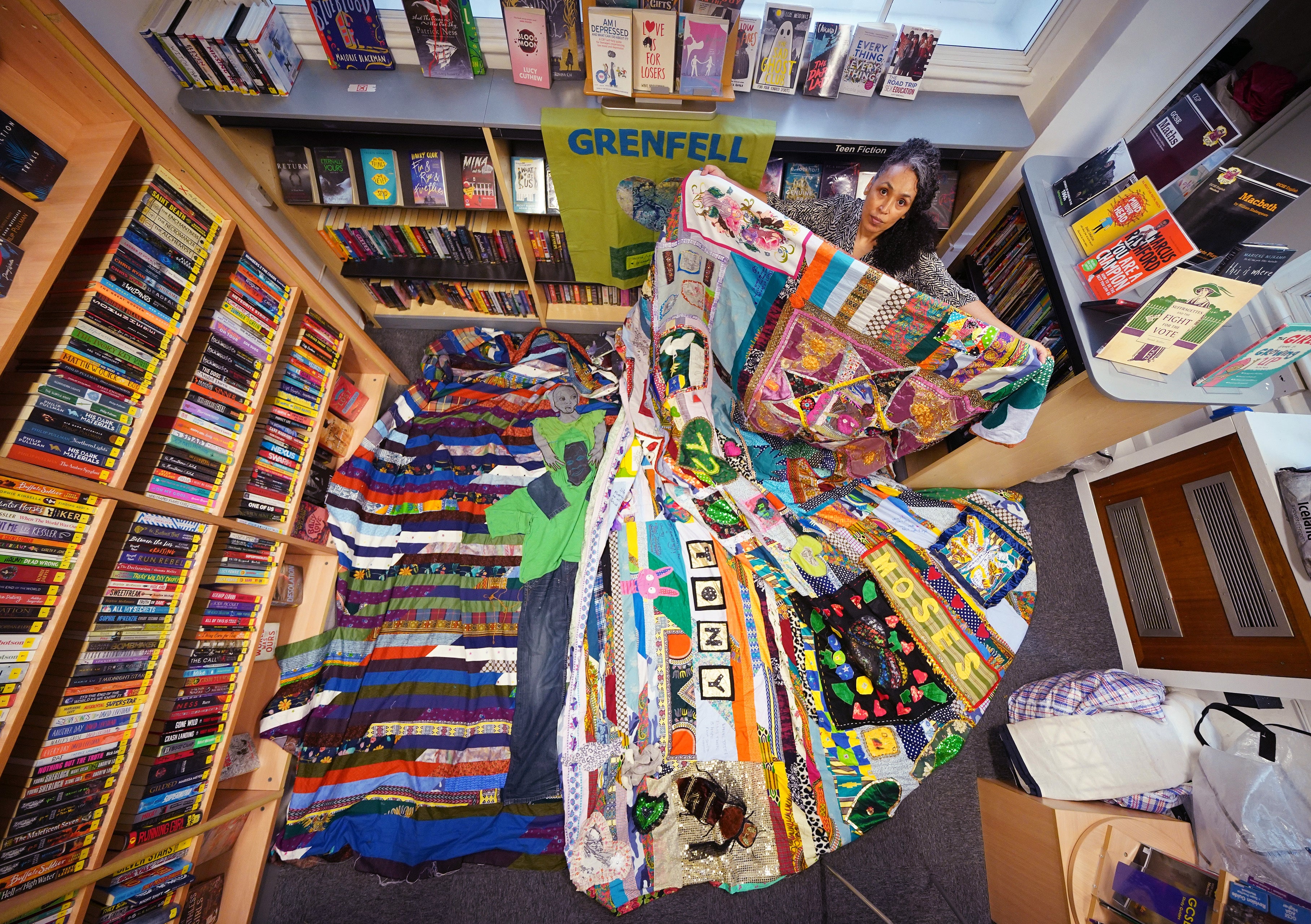 EMBARGOED TO 2230 WEDNESDAY JUNE 1 Artist Tuesday Greenidge, founder of the Grenfell Memorial Quilt Project, holding the work in progress, as Grenfell survivors, bereaved relatives and members of the wider community help to add to their 72-foot long memorial quilt, at North Kensington Library, ahead of the fifth anniversary of the Grenfell Tower fire which claimed 72 lives on June 14, 2017. Picture date: Tuesday May 31, 2022.