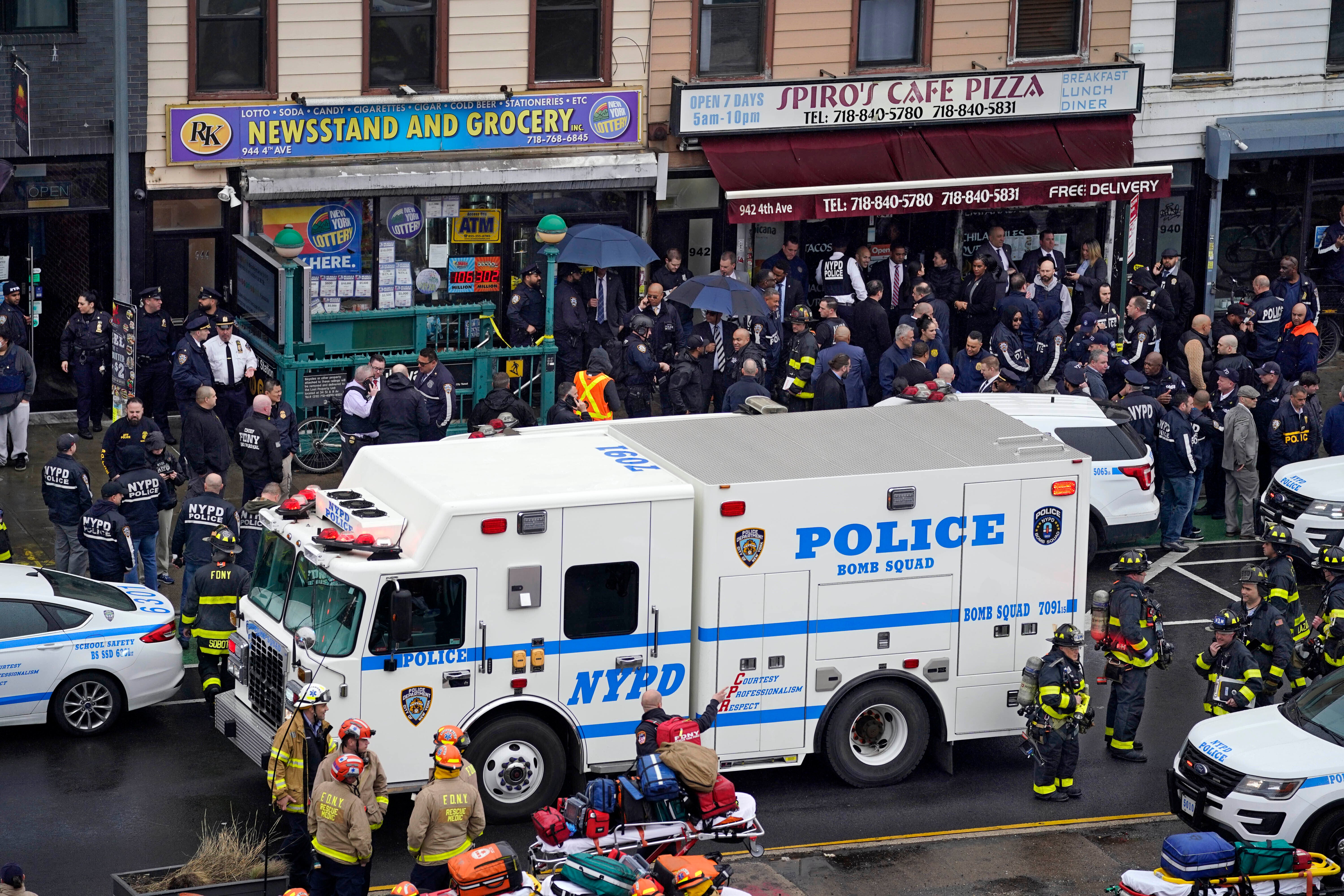 Emergency personnel gather at the entrance to a subway station in the Brooklyn borough of New York, after a gunman filled a rush-hour subway train with smoke and shot multiple people, April 12, 2022