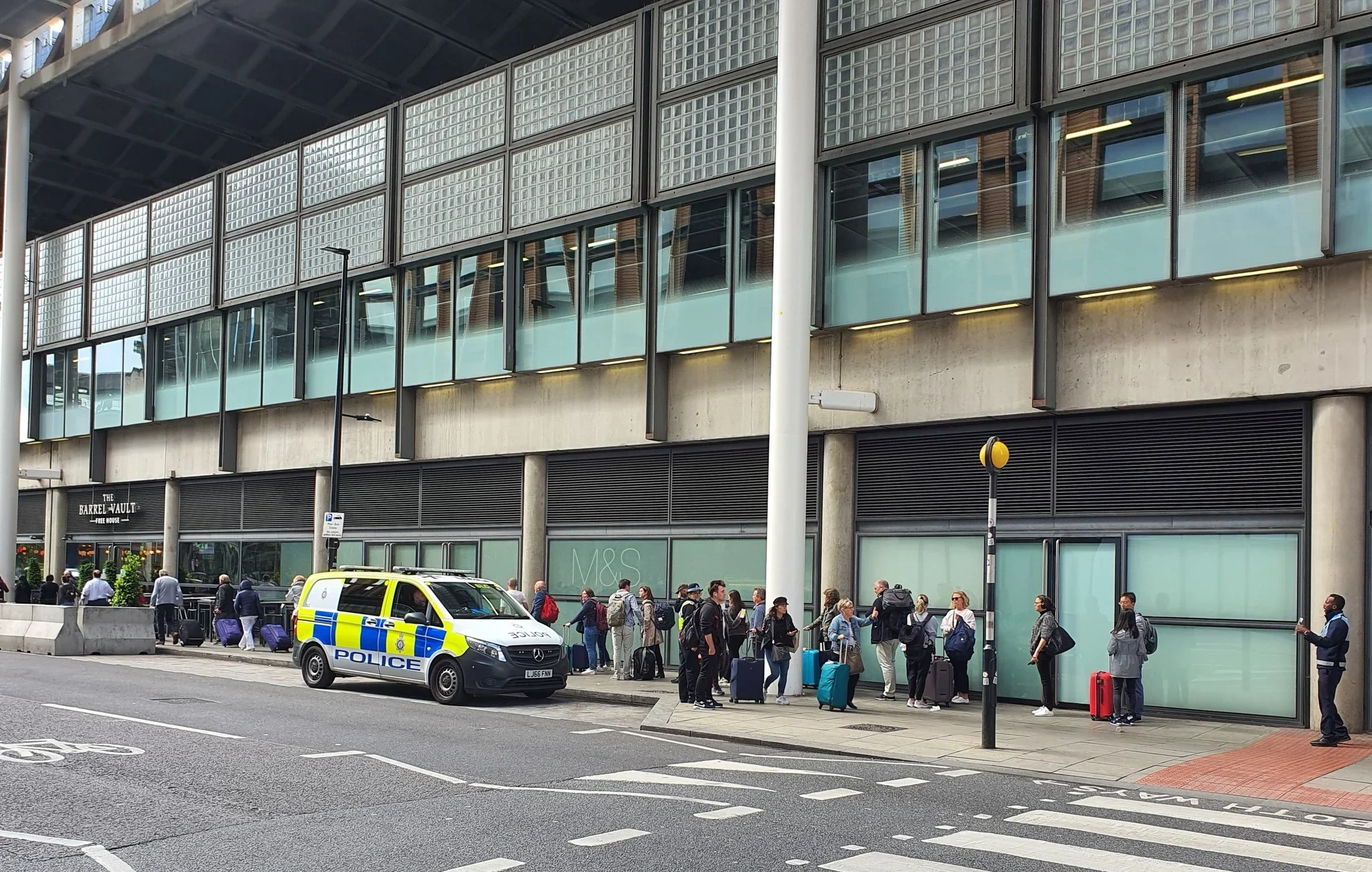 Passengers waiting outside St Pancras station on Tuesday